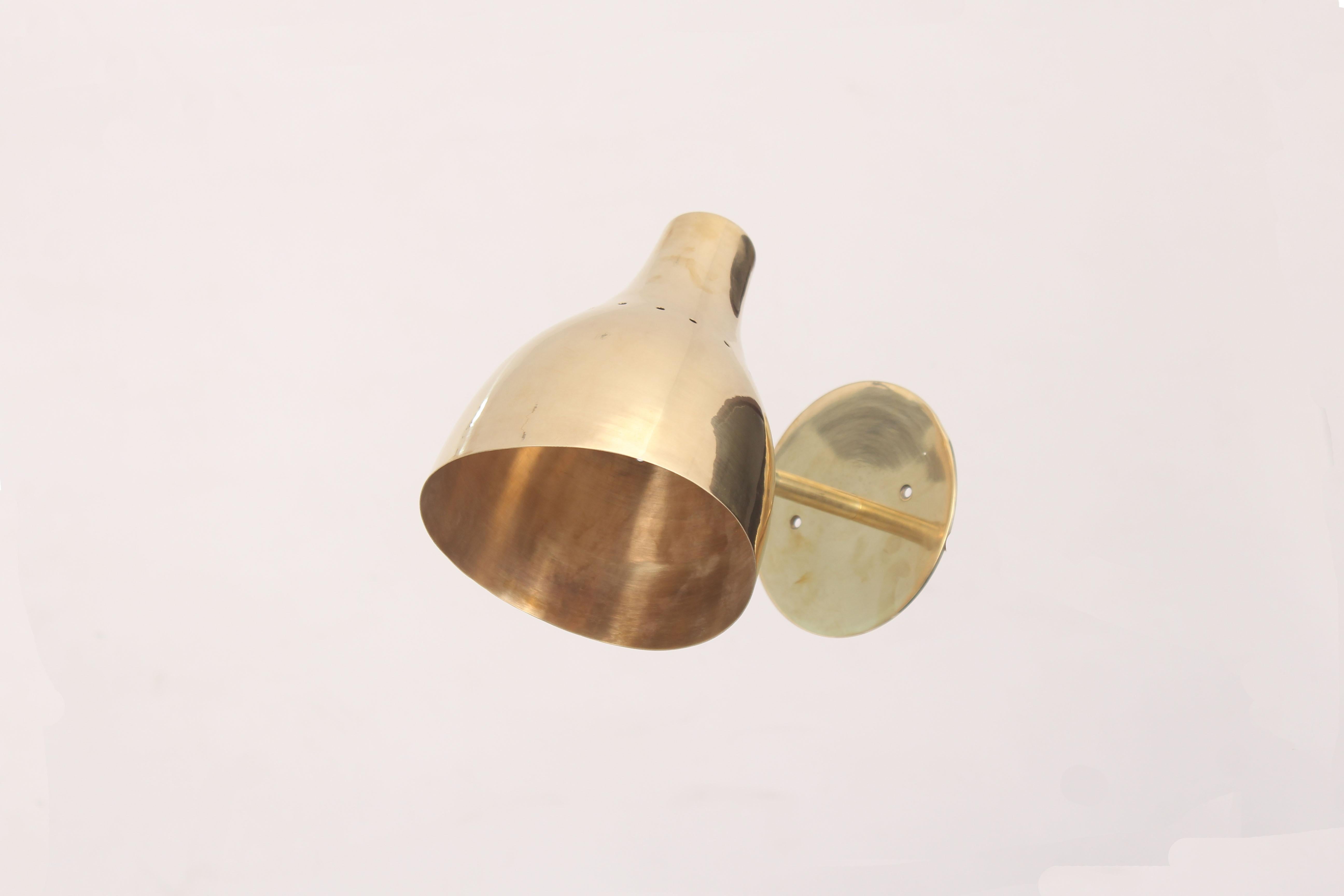 Elegant 50s style  wall sconces showed here in raw brass . 

Available in various brass finish and metal colored shade . 

Made with prime quality material and hardware . 

Solid sturdy  construction . 

Arm measure 4 in. long , shade 7 in. high by