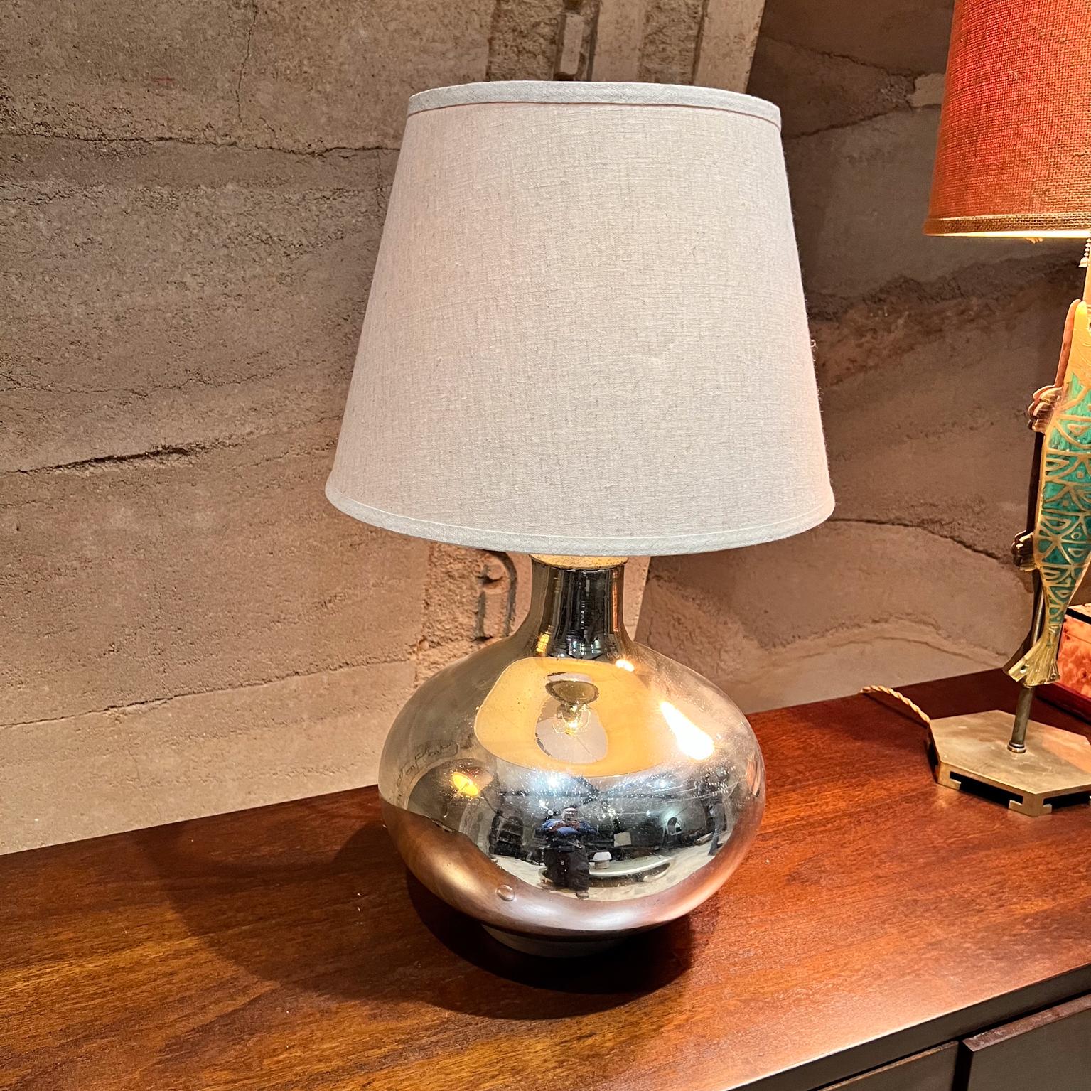 1950s Mercury Table Lamp Style of Luis Barragan Mexico
Wood base with silver leaf. 
18 h socket x 13 diameter
Rewired New socket, twisted gold cord and new plug with new switch. 
Tested and working.
 No label. 
No lamp is shade included.
Preowned