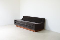 1950's style three-seater sofa with wooden base
