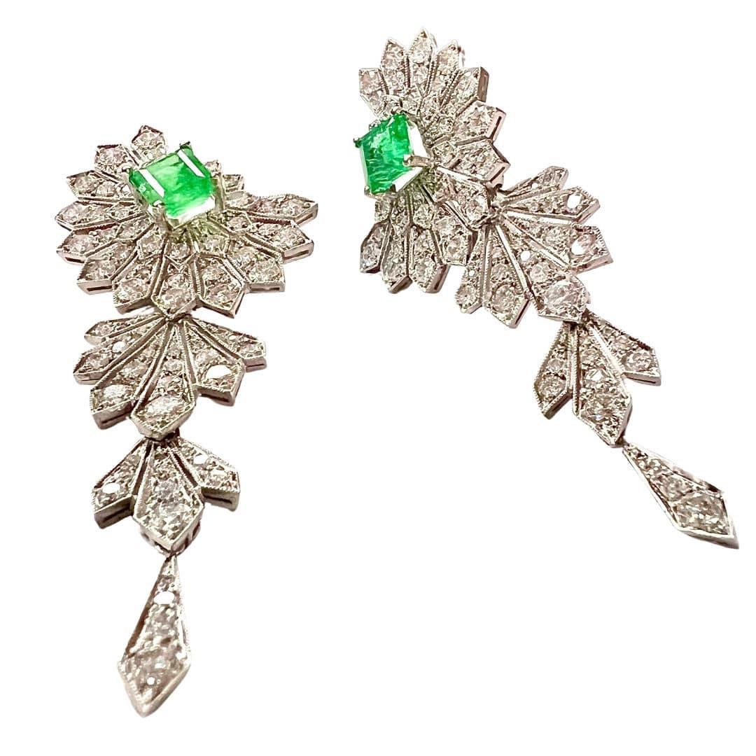 Immerse yourself in the glamour of the 1950s with these exquisite platinum earrings. Adorned with a dazzling array of brilliant-cut diamonds totaling 5 carats and center-cut carre emeralds sourced from Colombia, these earrings exude timeless