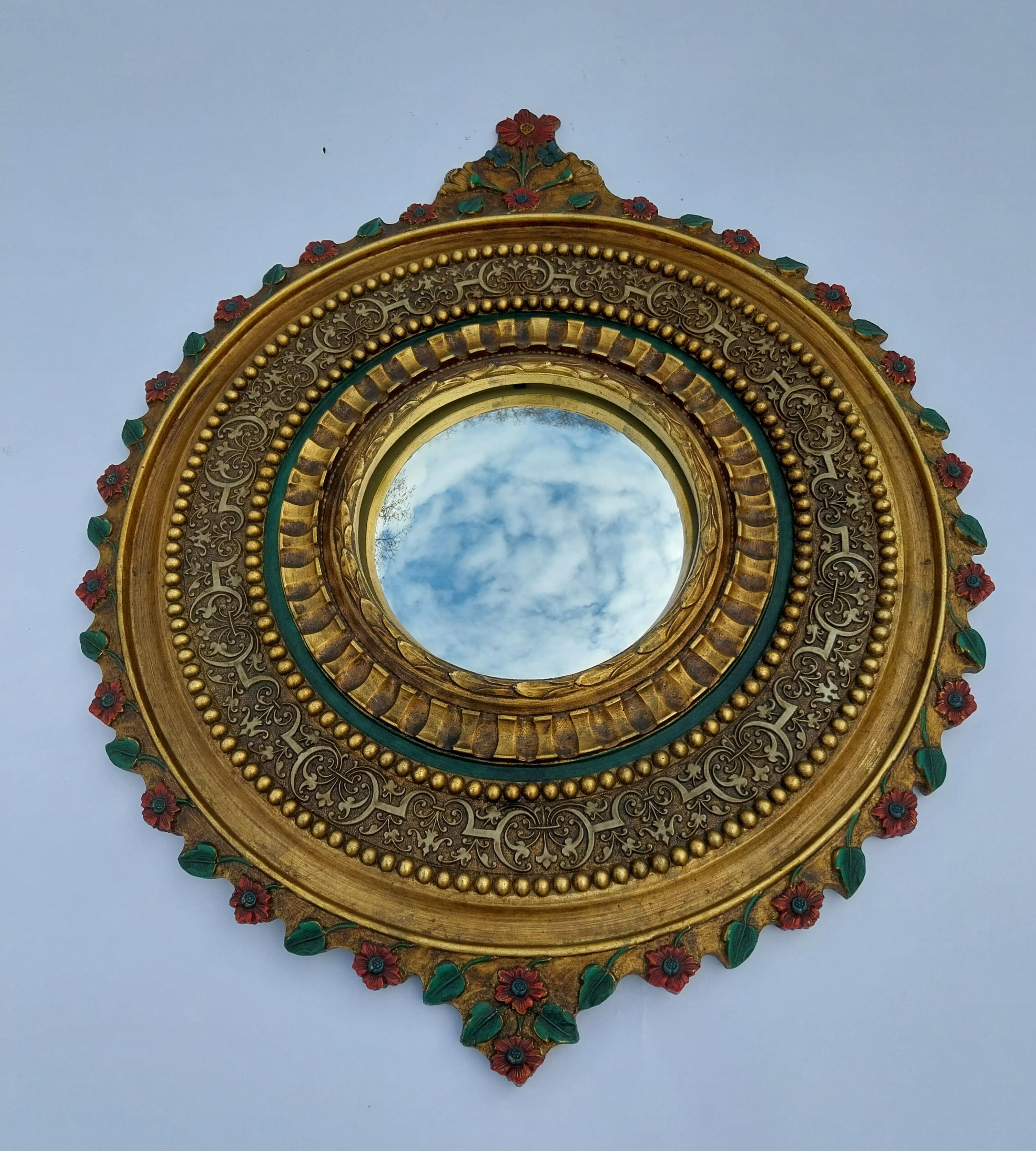1950's sunburst painted convex resin mirror 

Nice Renaissance revival mirror with some fine details.

Slightly curved (convex) mirror