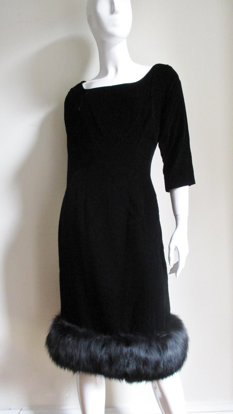 A fabulous 1950s little black silk velvet dress from Suzy Perette.  It has a square neckline with a scoop back and 3/4 length sleeves. Skimming the body it has a straight skirt with 7
