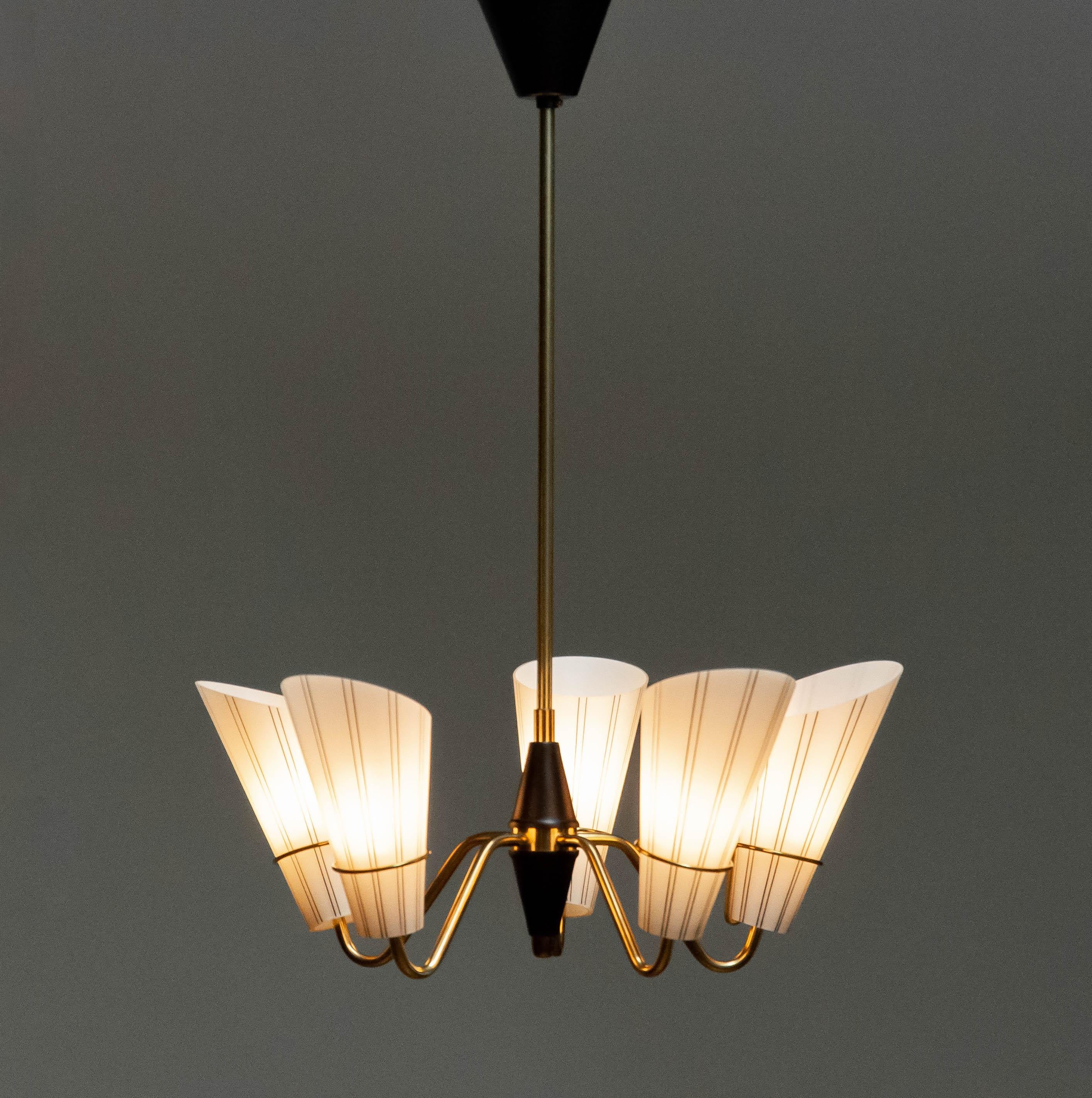 Lustre suédois en laiton combiné à du verre d'art opalin attribué au designer suédois Hans Bergstrom pour ASEA en Suède.
Cinq bras en laiton, chacun avec un raccord à vis de taille E14.
Techniquement et globalement en très bon état. 
