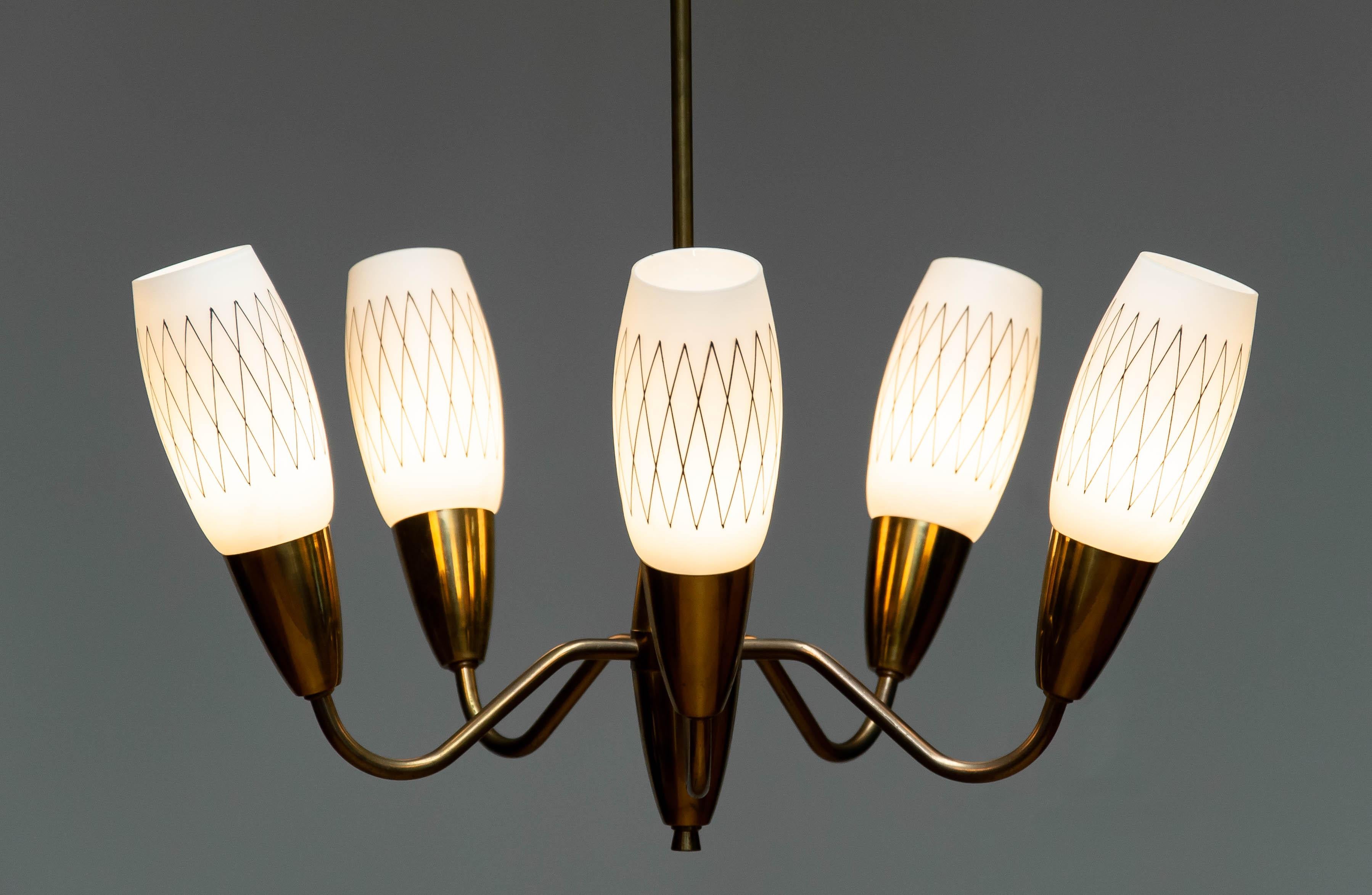  Sweden, circa 1950s—an era renowned for its aesthetic elegance and craftsmanship in lighting design.
 A refined combination of warm brass and matte or patterned opal (opaline) glass shades, offering a soft, glowing ambience typical of Scandinavian