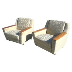 Paire de fauteuils club suédois modernes des années 1950 avec accoudoirs en bois sur roulettes