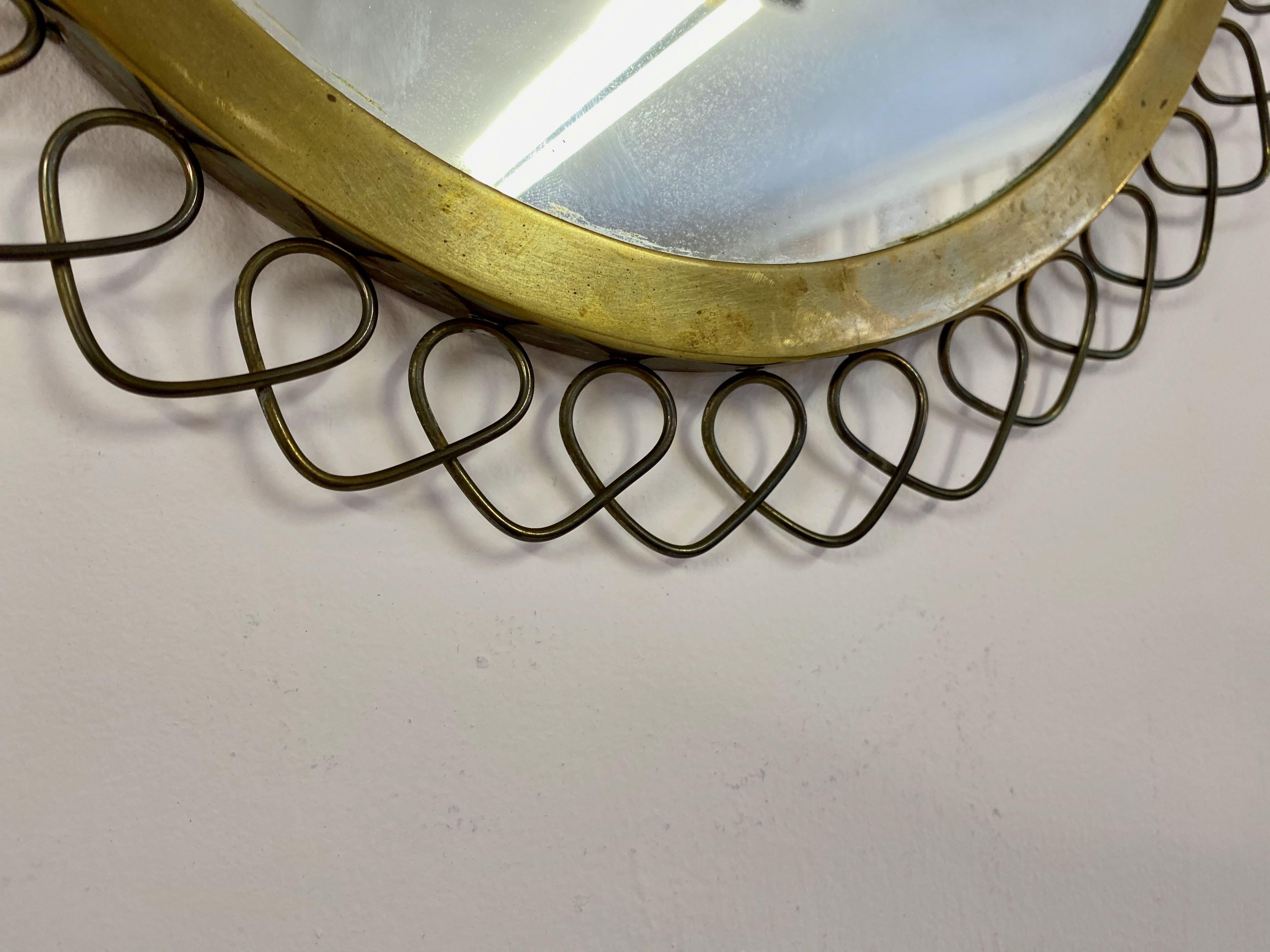 Patinated brass mirror

Brass wire decorated surround

Swedish,

1950s/1960s.