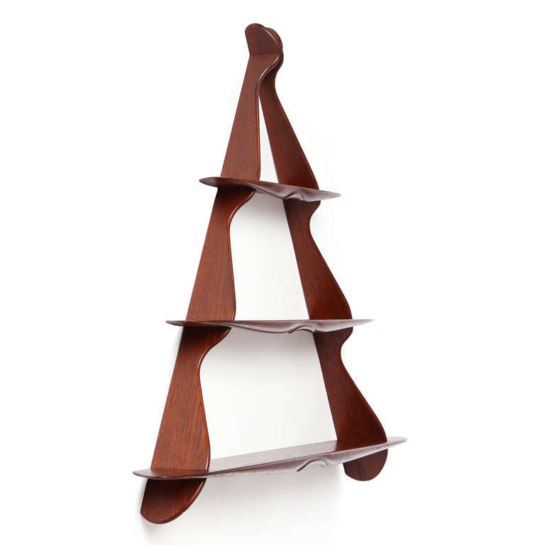 A well-crafted triangular shaped three-tiered wall-mounted shelf.