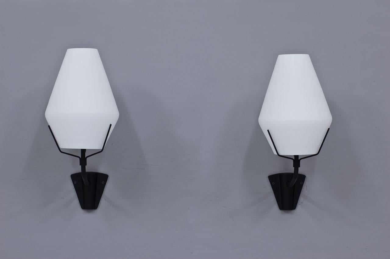 Pair of large wall lamps produced by ASEA in Sweden during the 1950s.
Black lacquered metal structure with opaline glass diffuser.