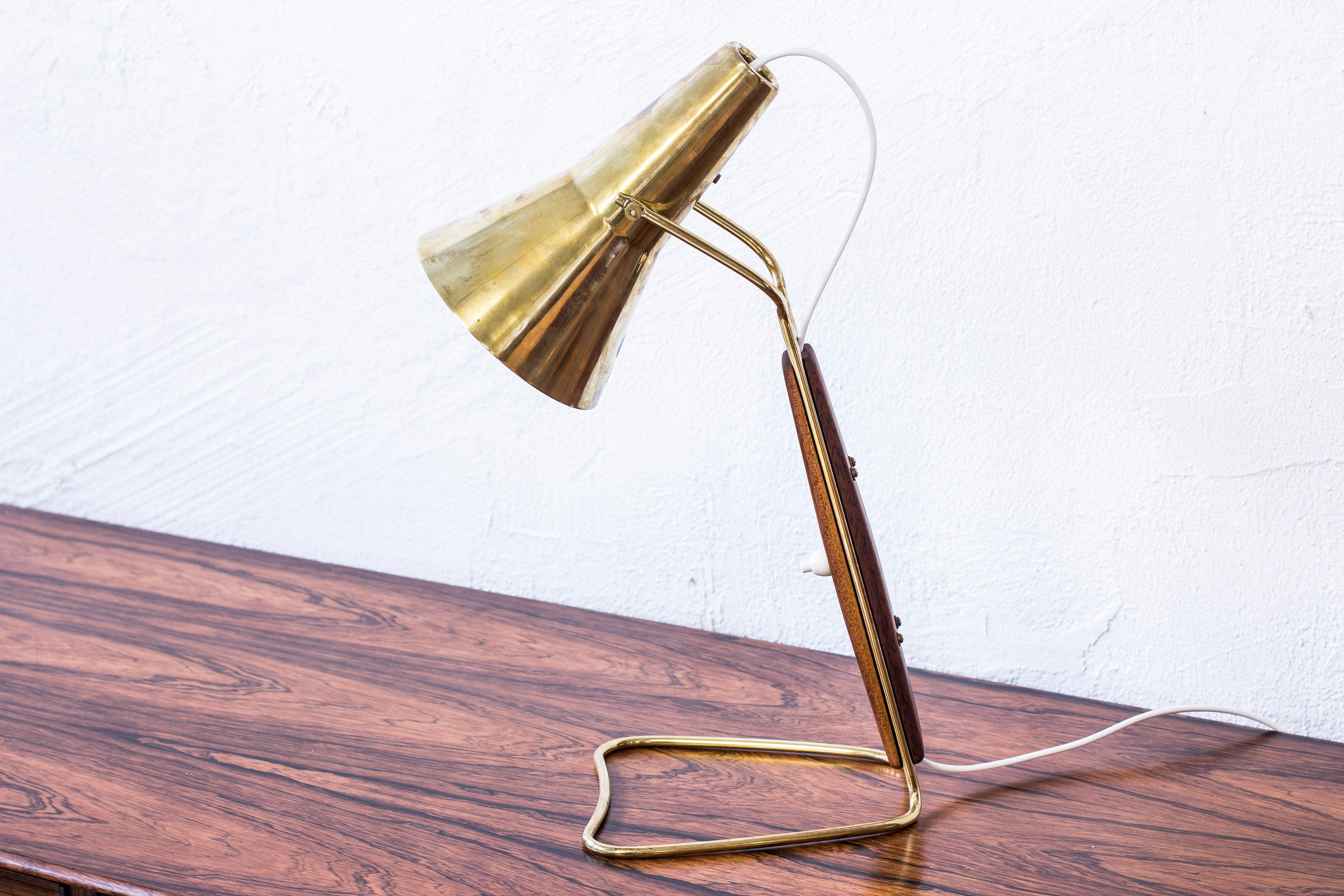 Rare table lamp produced by ASEA in Sweden. Attributed to Hans Bergström. Made from polished brass and solid mahogany. Light switch on the lamp in working condition. New electric cables. Very good condition with few signs of wear and light patina.
 