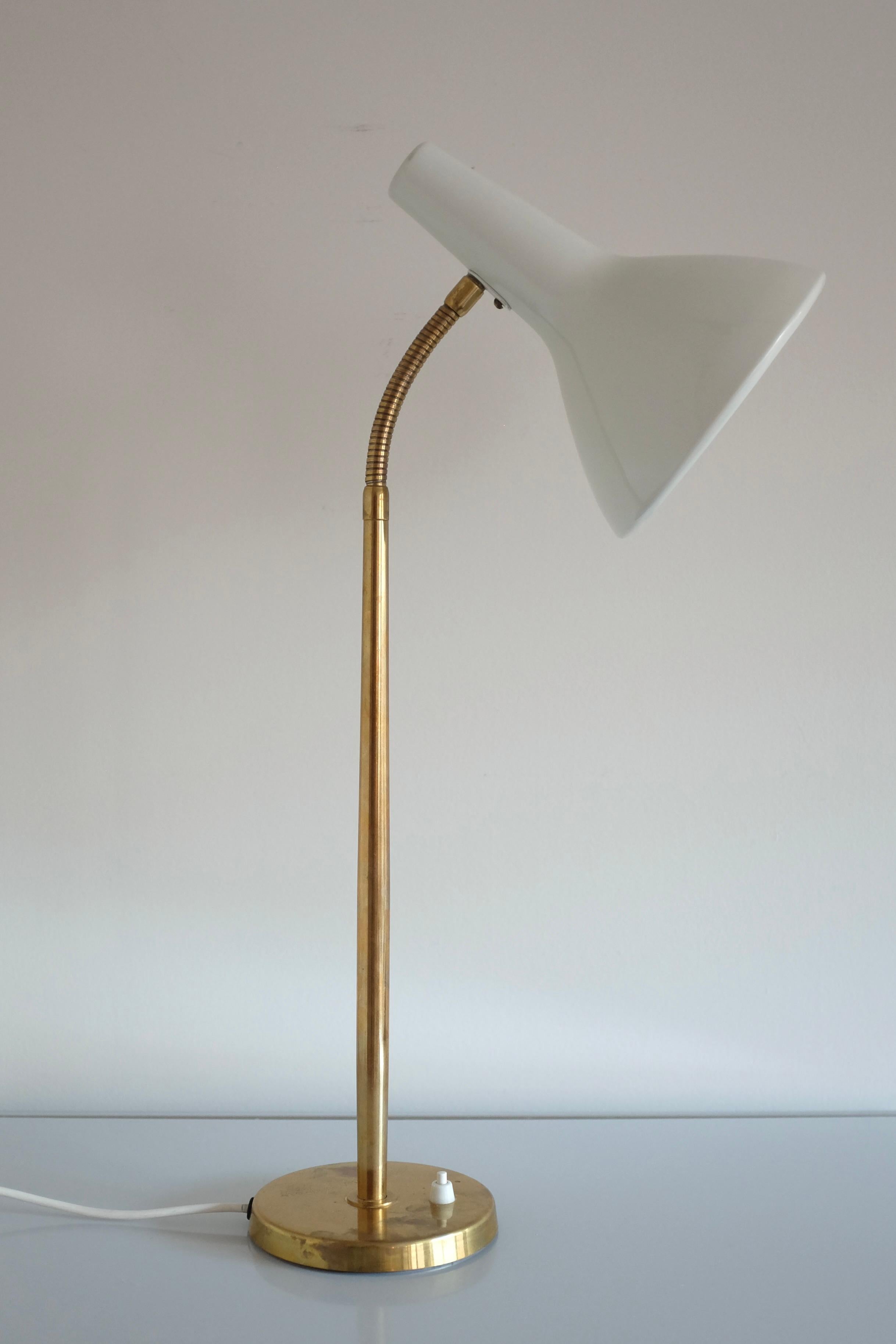 1950s Table Lamp by Harald Notini for Arvid Böhlmarks Lampfabrik, Stockholm, Sweden. Adjustable arm in brass with a white lacquered shade. Age appropriate wear to the brass and overall in a very good vintage condition. Marked with the modell number
