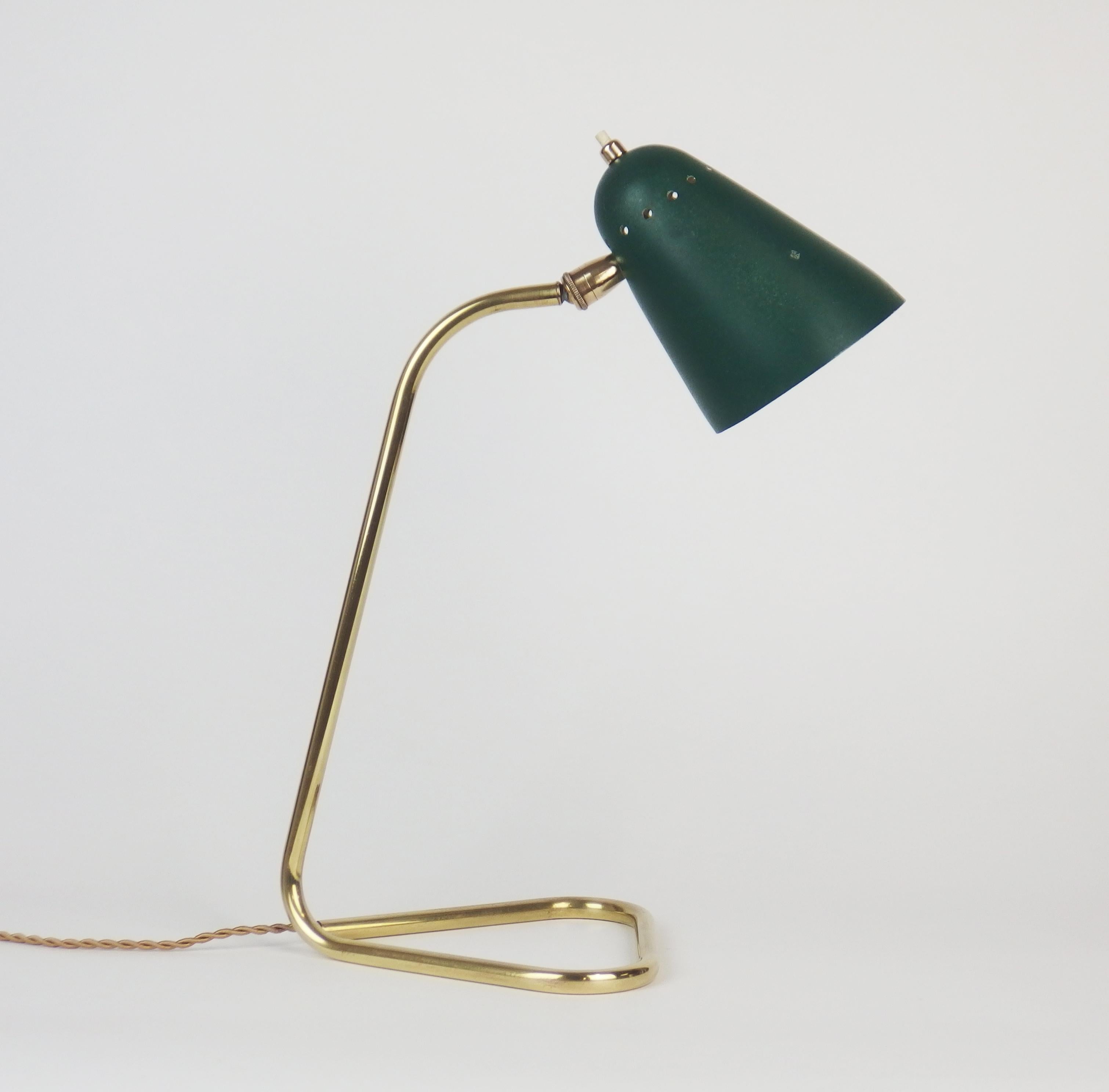 A rare 1950s table lamp by Robert Mathieu with a brass base and an adjustable green enameled aluminium shade.
The socket can be replaced by an American socket.
