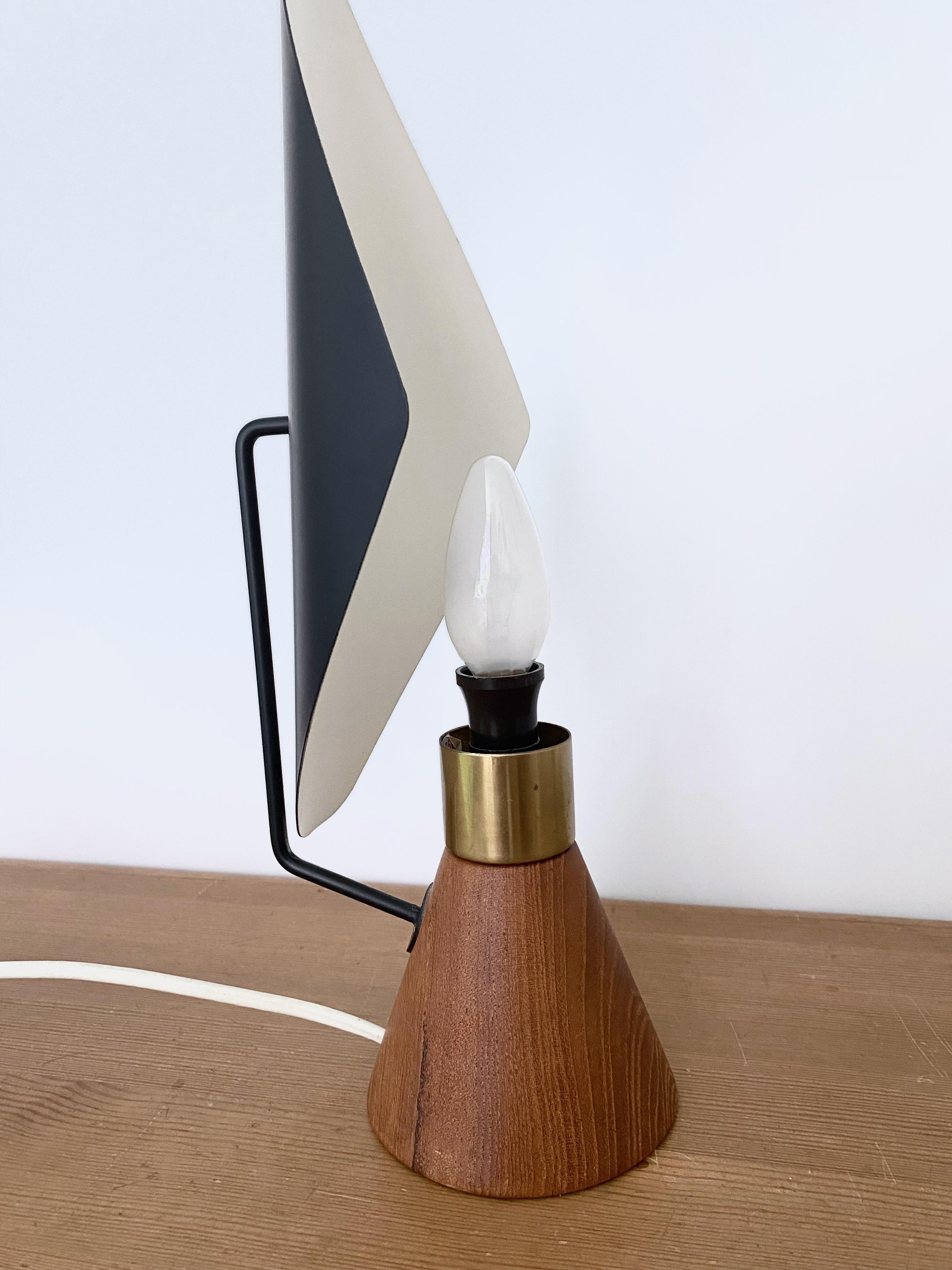 Rare table lamp by Svend Aage Holm-Sørensen for ASEA, Sweden. Designed in the 1950s with a teak base and metal shade it has a very dramatic and striking look. Missing original lamp bulb but otherwise in a very good condition with small marks to the