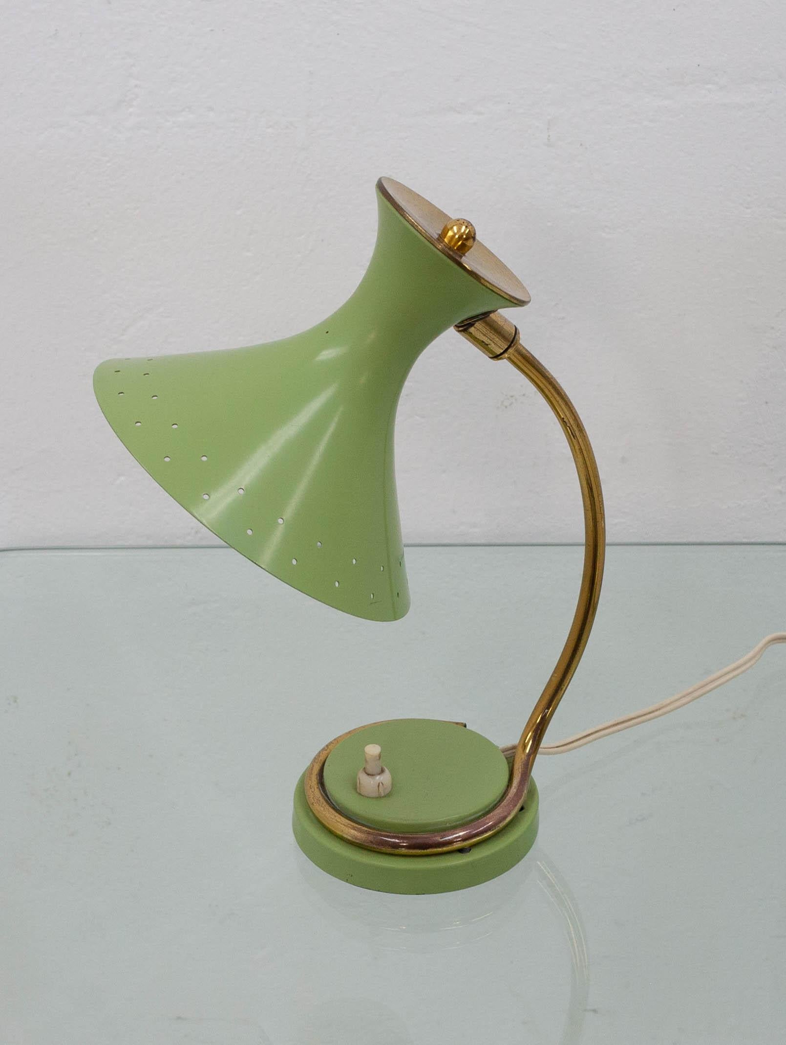 Adorable little table lamp in the style of Mategot featuring a brass arm which wraps around most of the base before going up to a horn-shaped lampshade. Still in its original light avocado green paint.
    