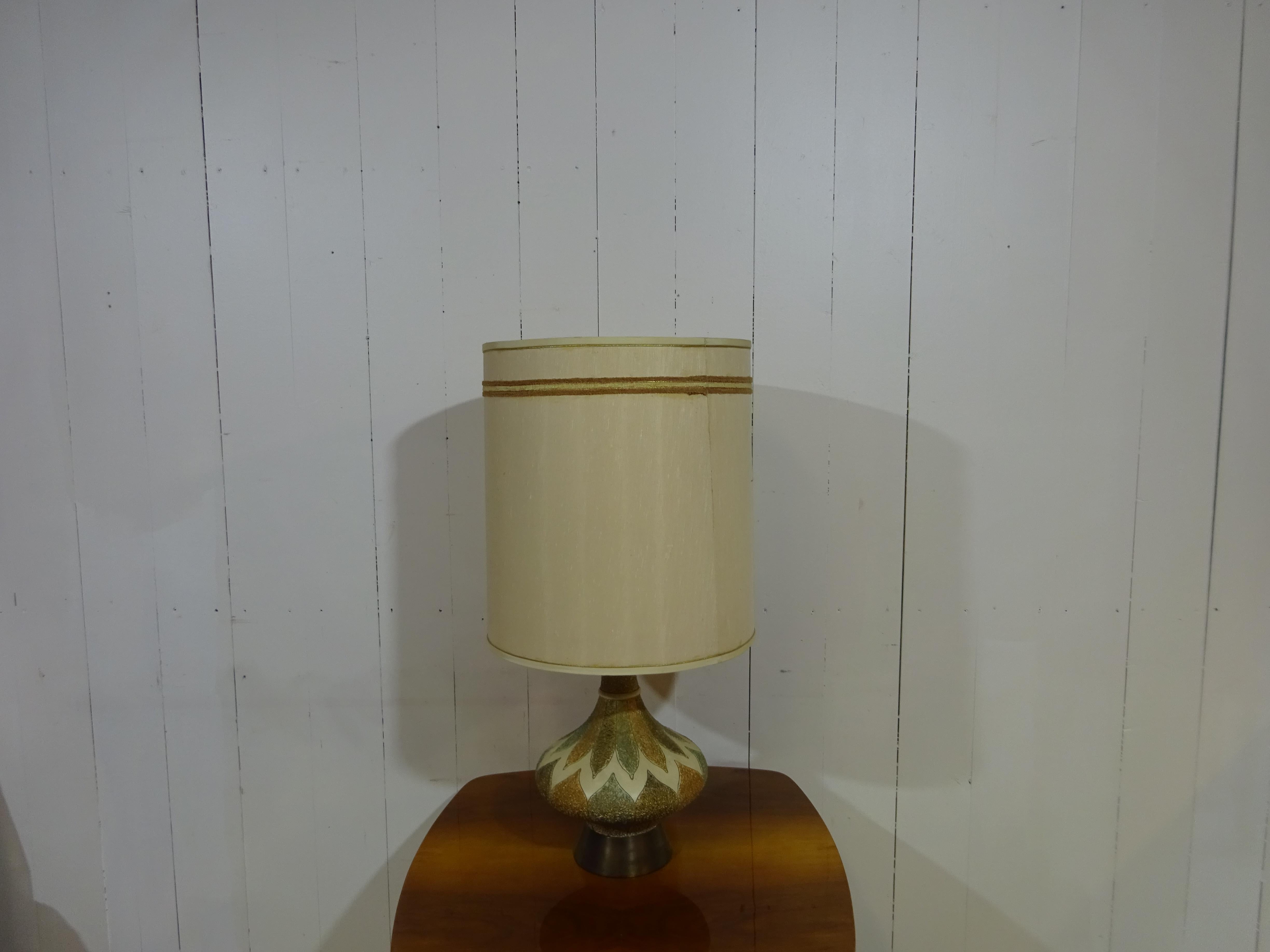 Table Lamp 

What a great find by the team. 

This is an original late 1950's table lamp. In the same family from new we have this smaller one and a matching larger lamp. The base is heavy and finished with a brass section. Above is a beautiful