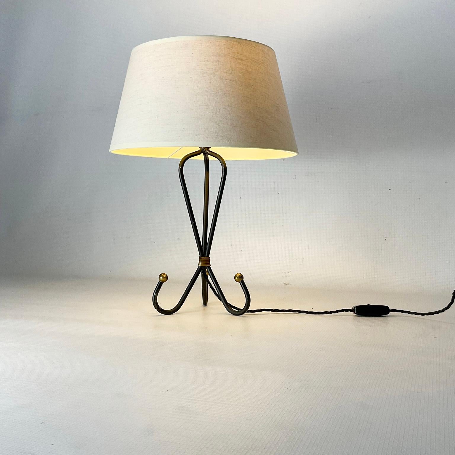 1950s table lamp in the style of Jean Royère
With a wrought iron body and brass balls finish
Features linen lampshade and has been newly rewired with an in-line manual switch.


 