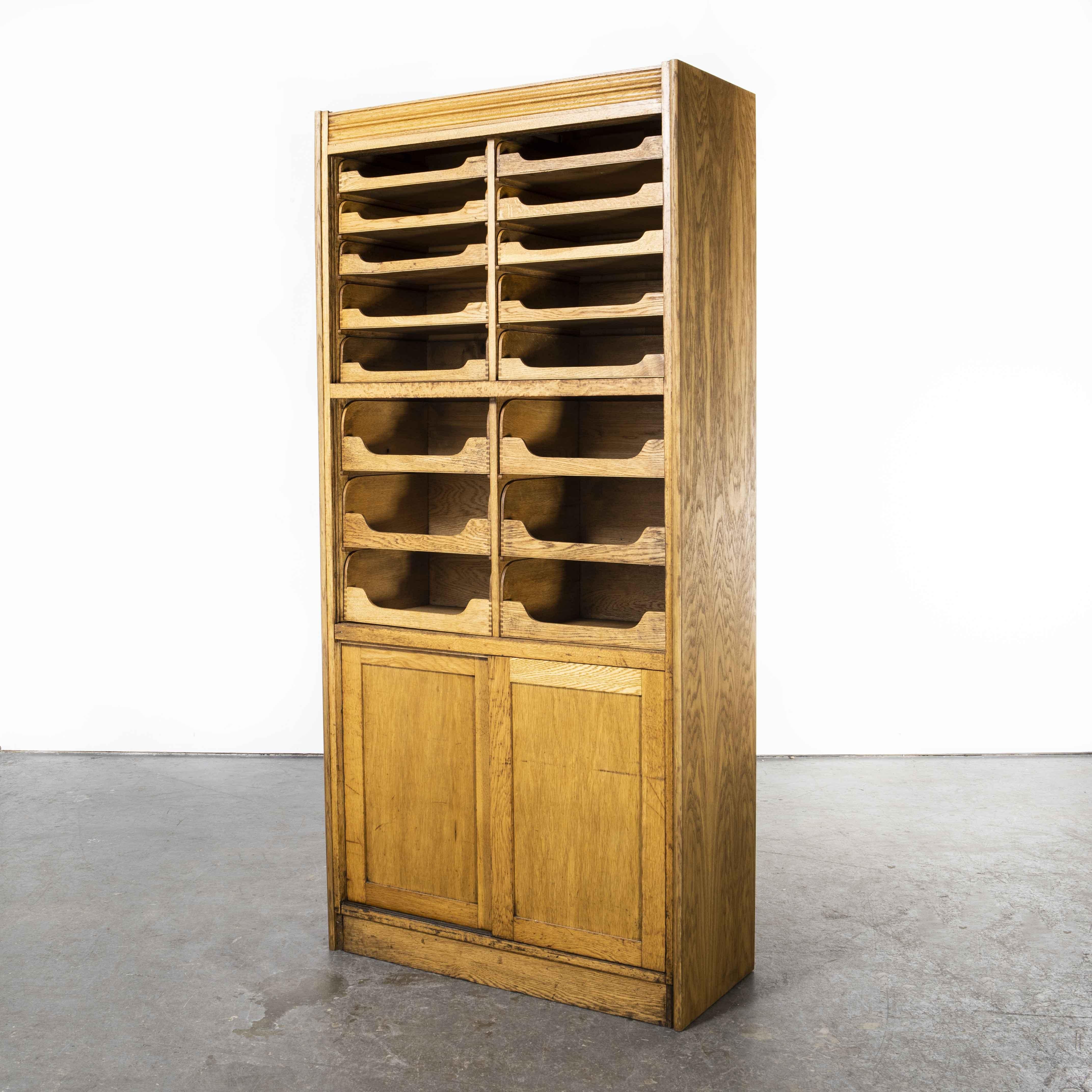 1950’s Tall English Haberdashery Shelved cabinet – Sixteen drawers (Model 1244.1)
1950’s Tall English Haberdashery Shelved cabinet – Sixteen drawers. An early 1950’s tall haberdashery/tailors shop display cabinet. Beautifully made in oak by a