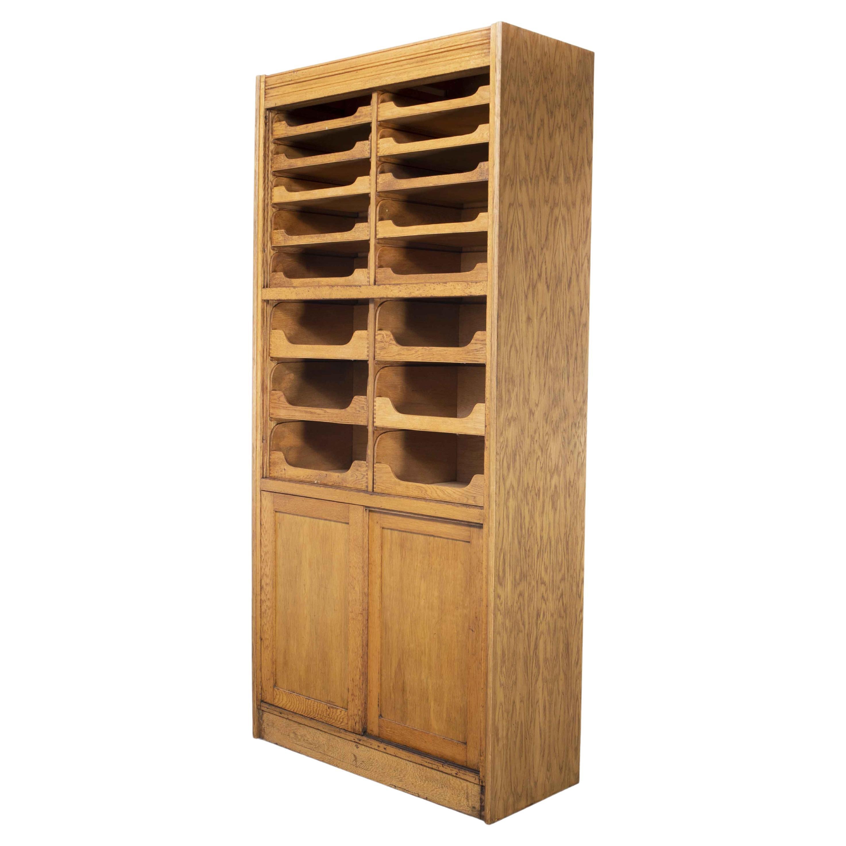 1950's Tall English Haberdashery Shelved Cabinet, Sixteen Drawers Model 1244.2 For Sale