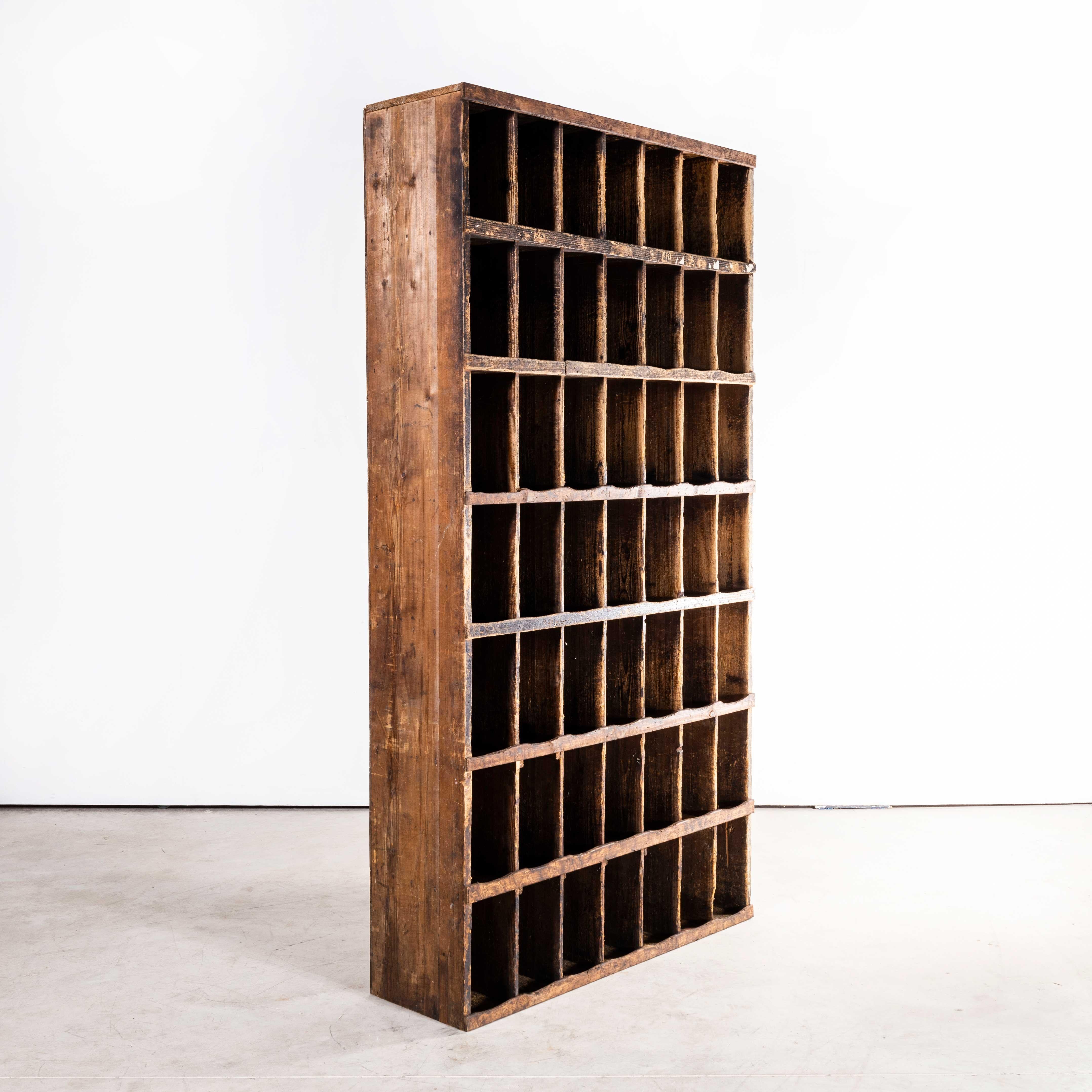 1950s Tall French pigeon hole unit
1950s Tall French pigeon hole unit. Original French Pigeon hole shelving unit with 49 pigeon holes. Made from solid pitch pine. Sourced from a shoe factory in south west of France, the pigeon holes were used to