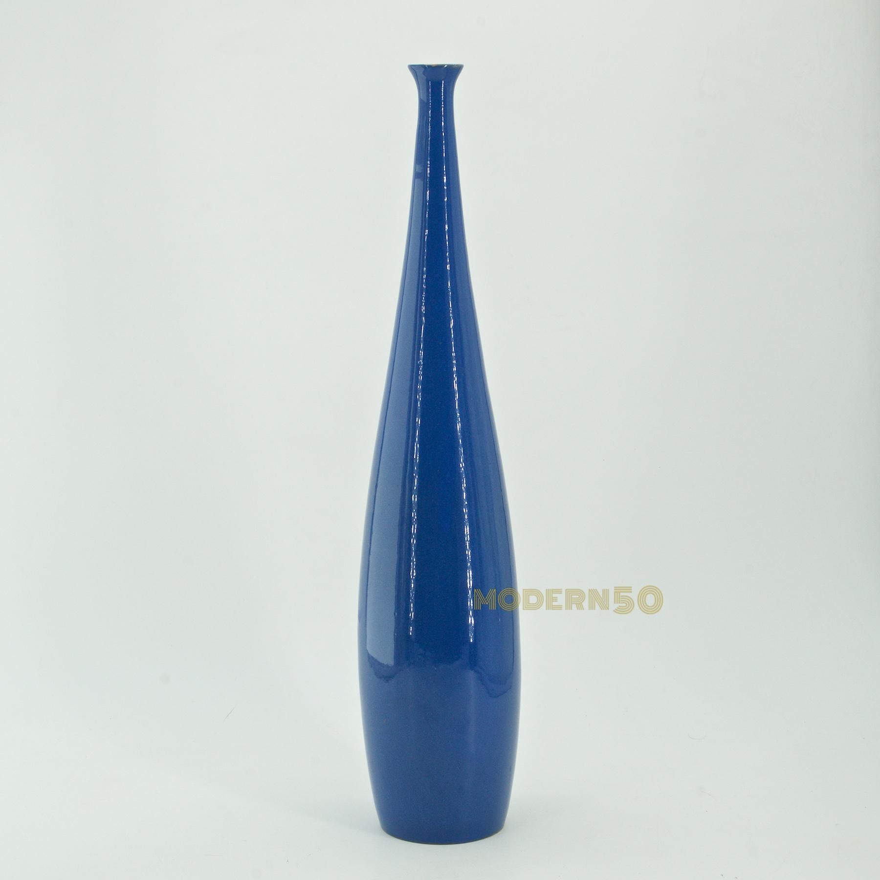 Un élément de décor tout droit sorti d'un tableau de Giorgio Morandi. Vase en forme de bouteille à col étroit, en glaçure bleue brillante, moulé à la main.