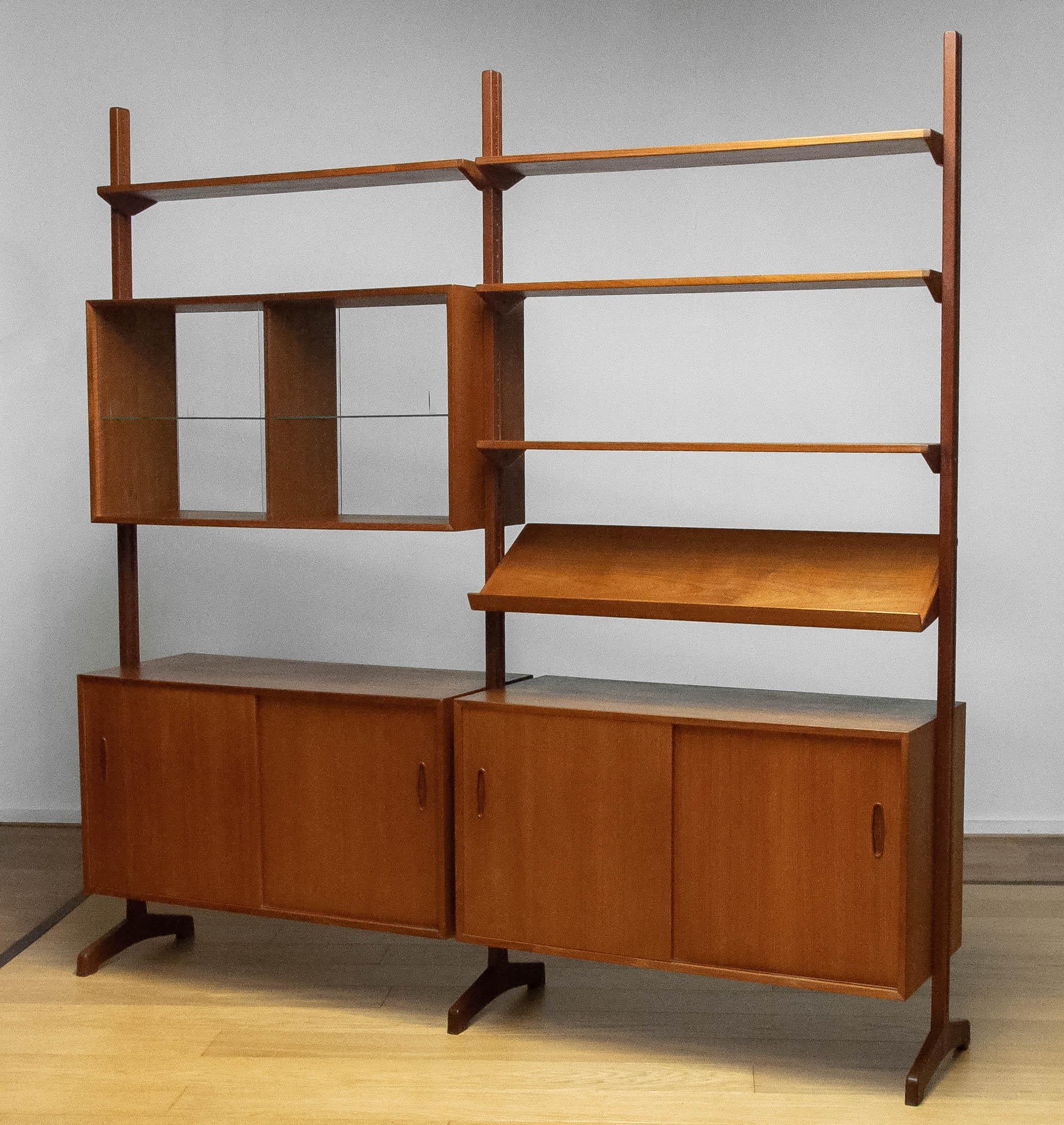 Beautiful teak 'all in one' masterpiece cabinet 'model Domi' designed by Nils Jonsson for Hugo Troeds Sweden. ( displayed in the Bra Bohag catalogue ) This fee standing modular system can de used as a room divider as well. All shelfs are adjustable