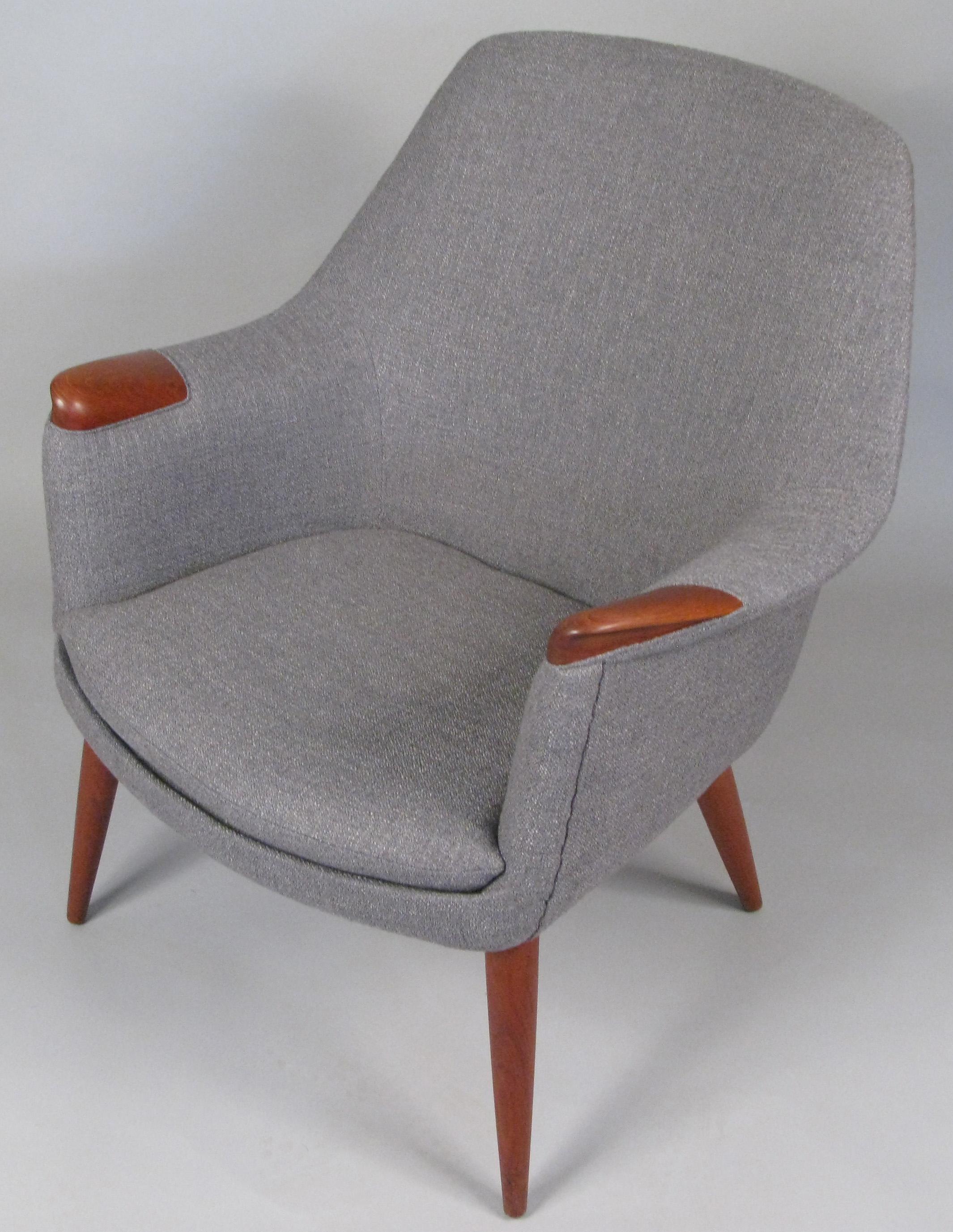 A truly stunning and beautiful 1950s lounge chair designed by Gerhard Berg and made by LK Hjelle, with solid teak legs and inset arms. Expertly reupholstered in a soft grey wool fabric. We also have the companion high back lounge chair that was