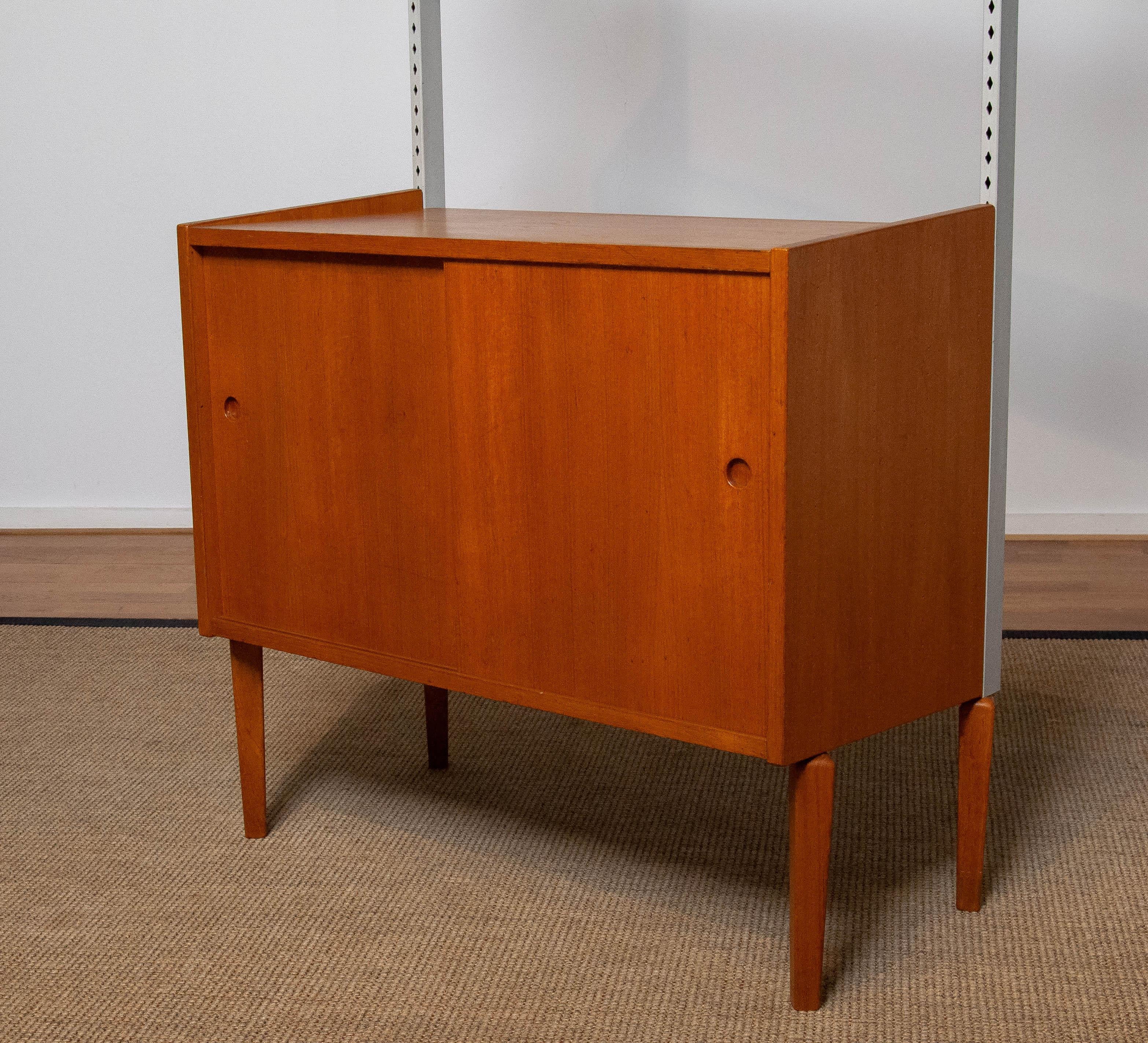 Swedish 1950's Teak Shelf System / Bookcase in Teak with Steel Bars by Harald Lundqvist For Sale