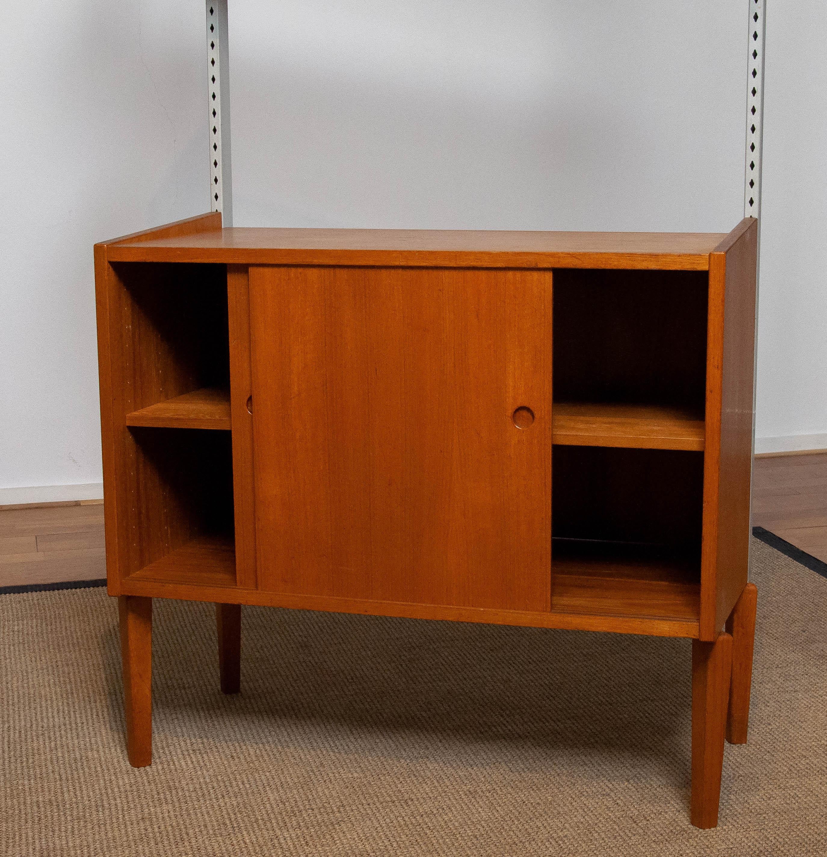 Veneer 1950's Teak Shelf System / Bookcase in Teak with Steel Bars by Harald Lundqvist For Sale