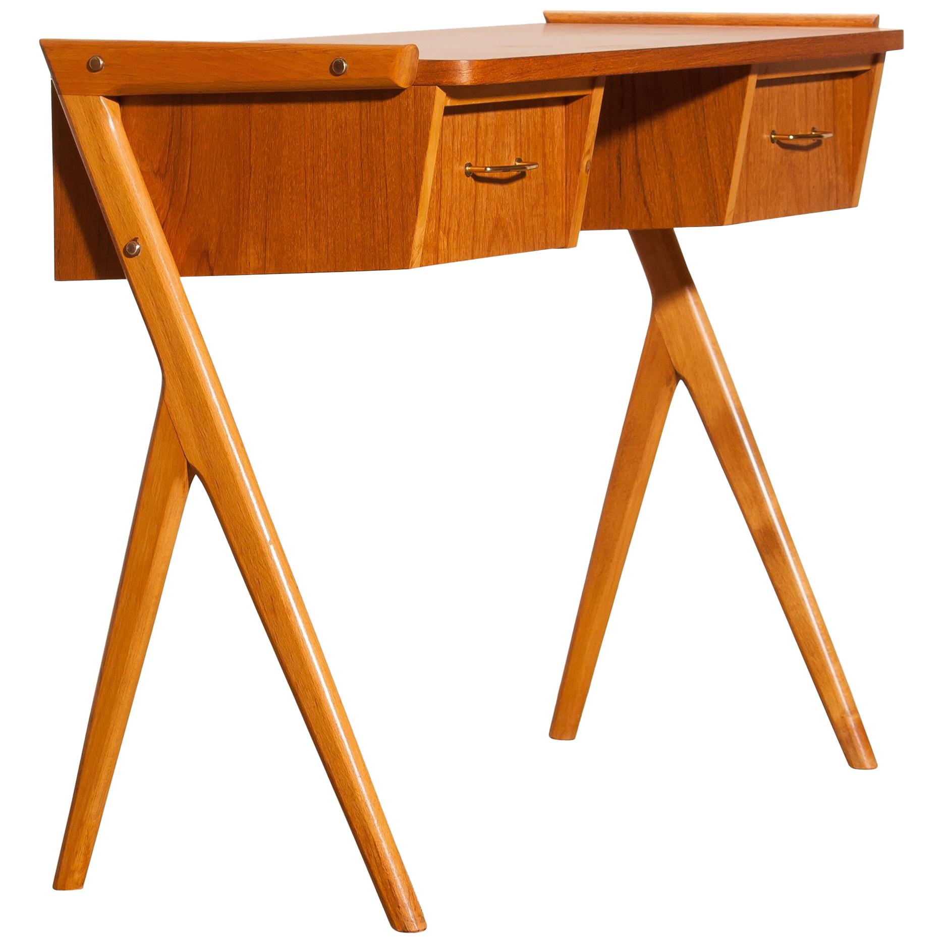 Very beautiful Vanity / ladies desk from Sweden
The table is made of teak and has two drawers with brass details.
It is in a very nice condition.
Period, 1950s.
Dimensions: H 70 cm, W 84 cm, D 40 cm.
