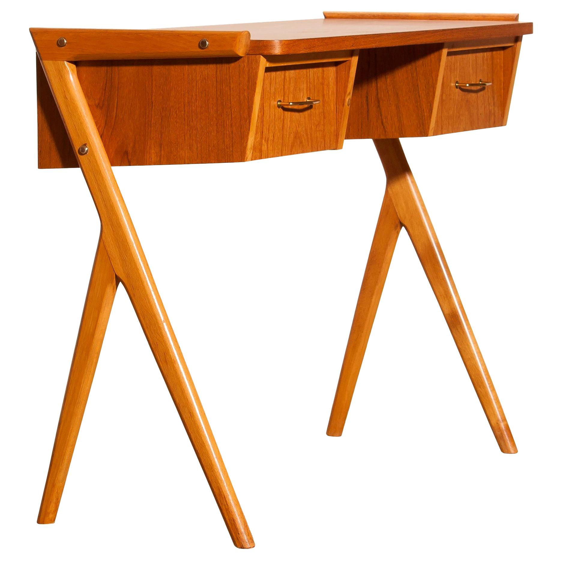 Very beautiful vanity or ladies desk from Sweden
The table is made of teak and has two drawers with brass details.
It is in a very nice condition.
Period, 1950s.
Dimensions: H 70 cm, W 84 cm, D 40 cm.