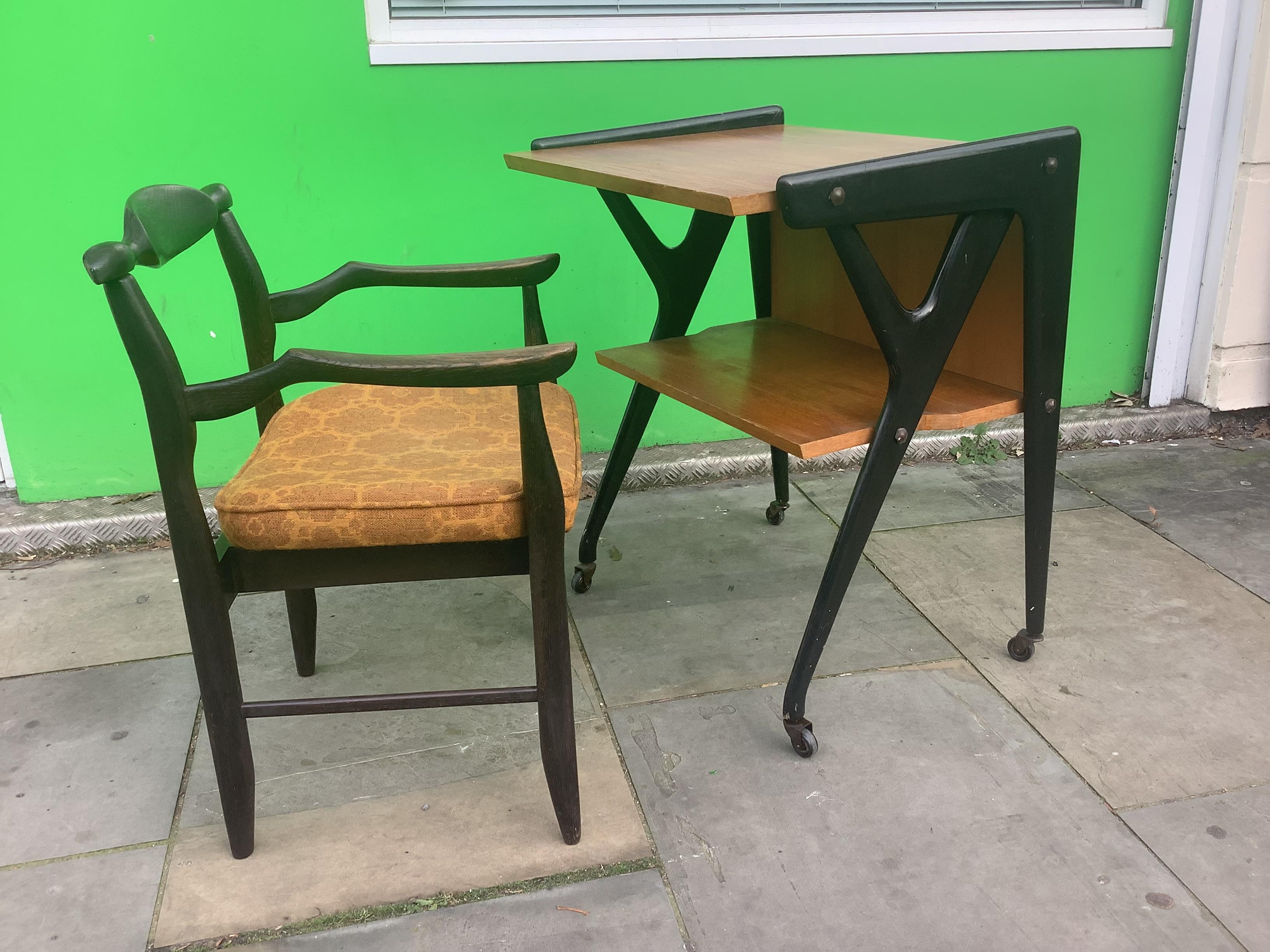 Super Stylist table originally used for vintage TV easily re used as a desk
angled black legs with polished oak surface sitting on castors make it easy 
for mobility. Cc Italian