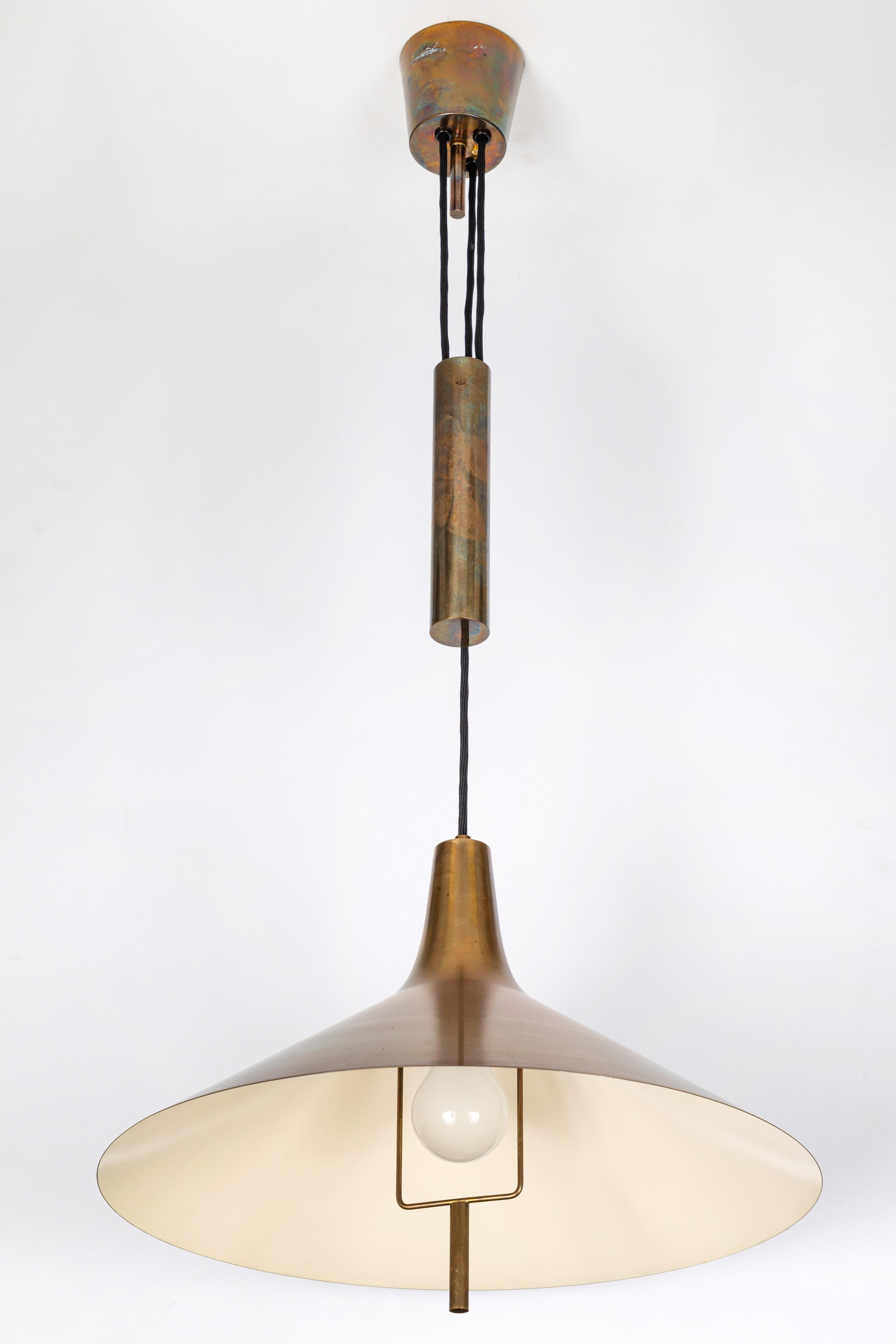 1950s TH Valentiner brass counterweight pendant. Executed in brass and thick black cloth adjustable length cord in the early 1950s. Reminiscent of the designs of Paavo Tynell and Lisa Johansson Pape, this highly sculptural design is a prime example