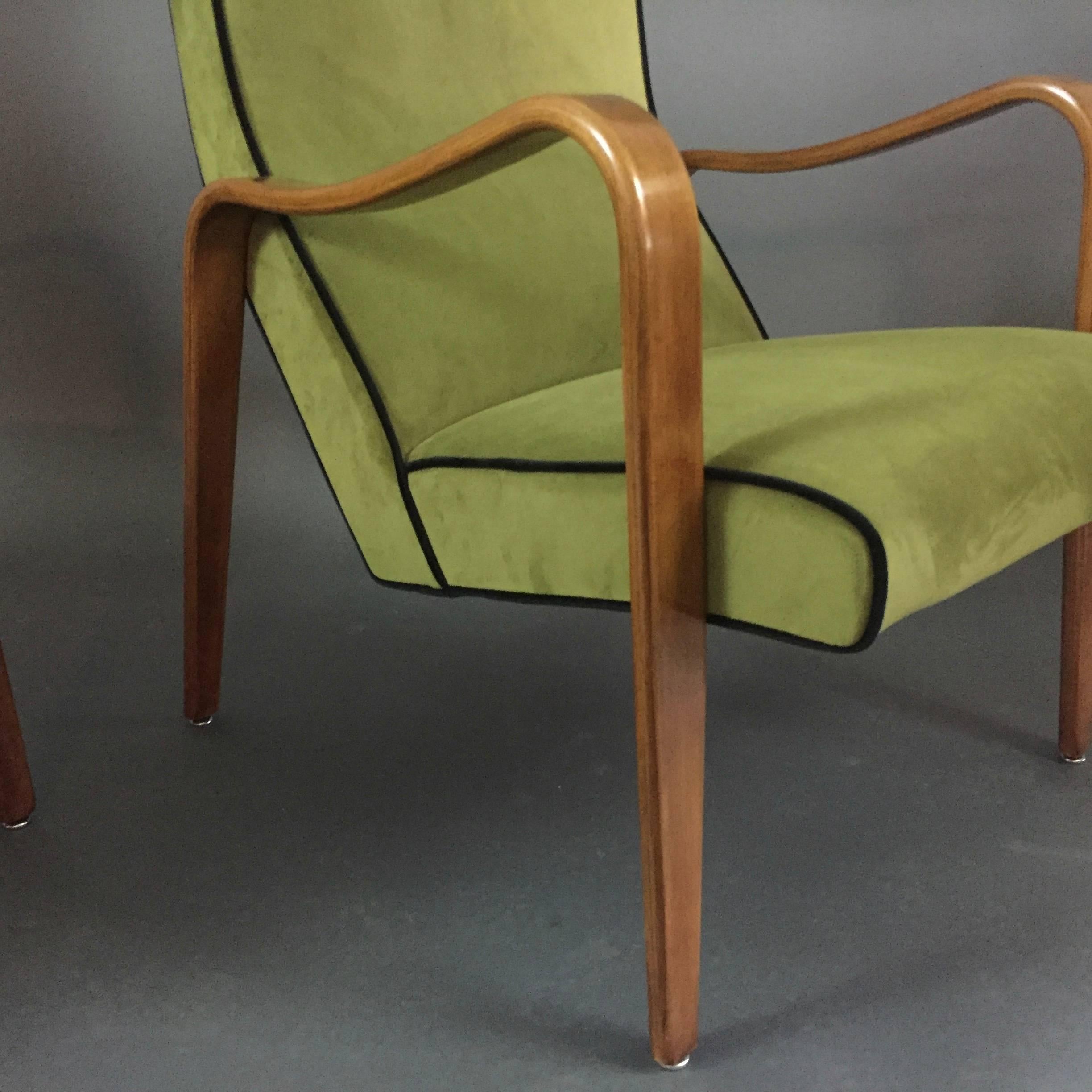 This is one of the coolest lounge chairs that came out of the Thonet USA studios in the 1950s fully in the laminated beech bentwood tradition with beautifully curved arms. This pair recently refinished and upholstered in green velvet with black