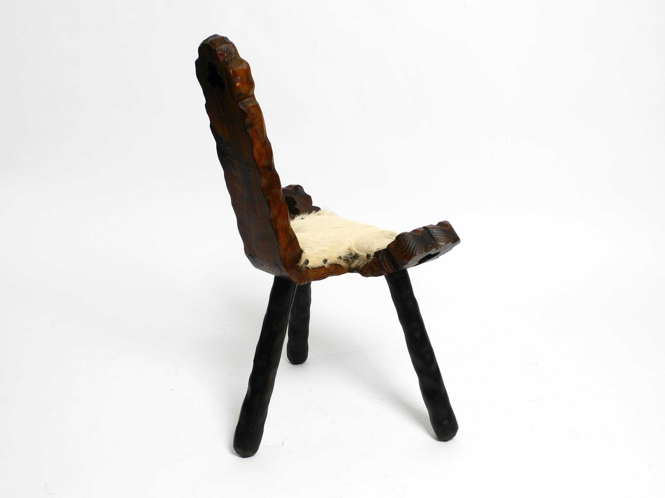 1950s three-legged stool made of solid wood in black-brown with cowhide seat For Sale 8