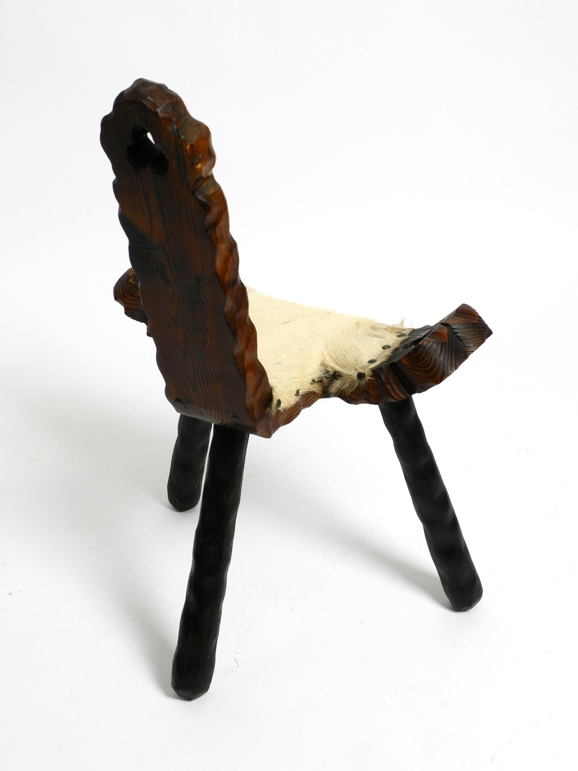 1950s three-legged stool made of solid wood in black-brown with cowhide seat For Sale 10