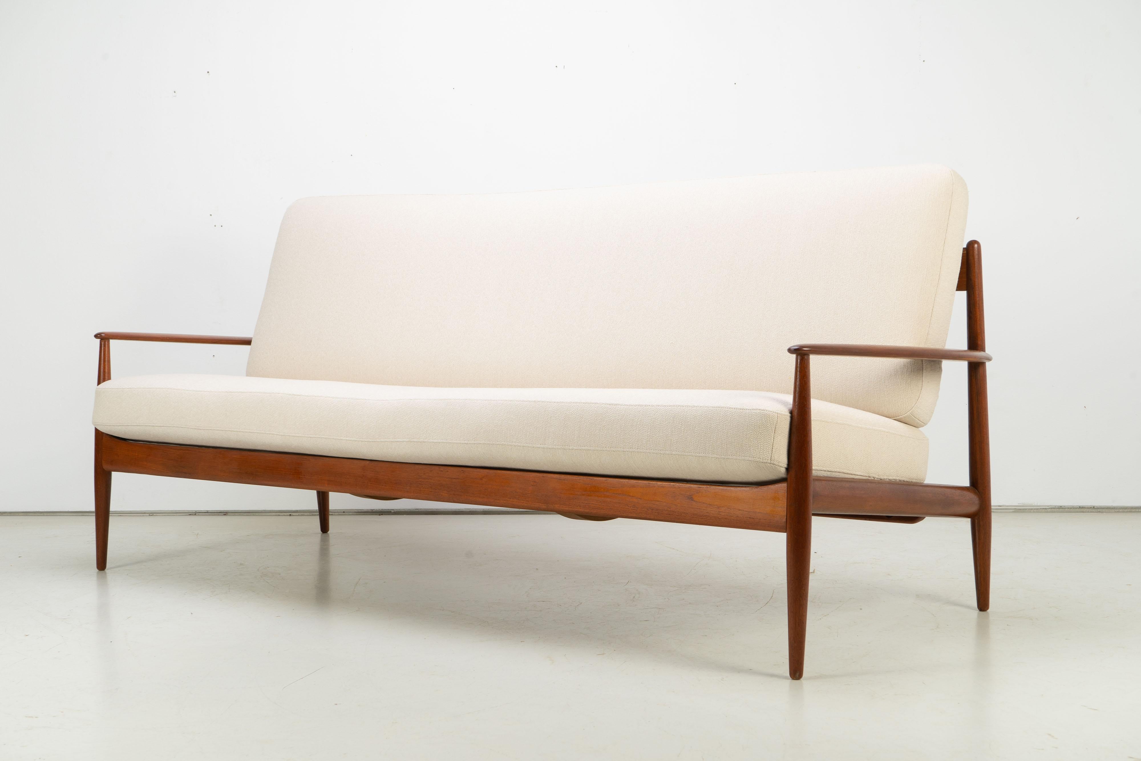 Teak sofa by Grete Jalk, produced by France & Søn in the late 1950s. Newly upholstered and covered with high quality upholstery fabric Arco by Rohi. New upholstery and refinished frame. Labeled on the inside.