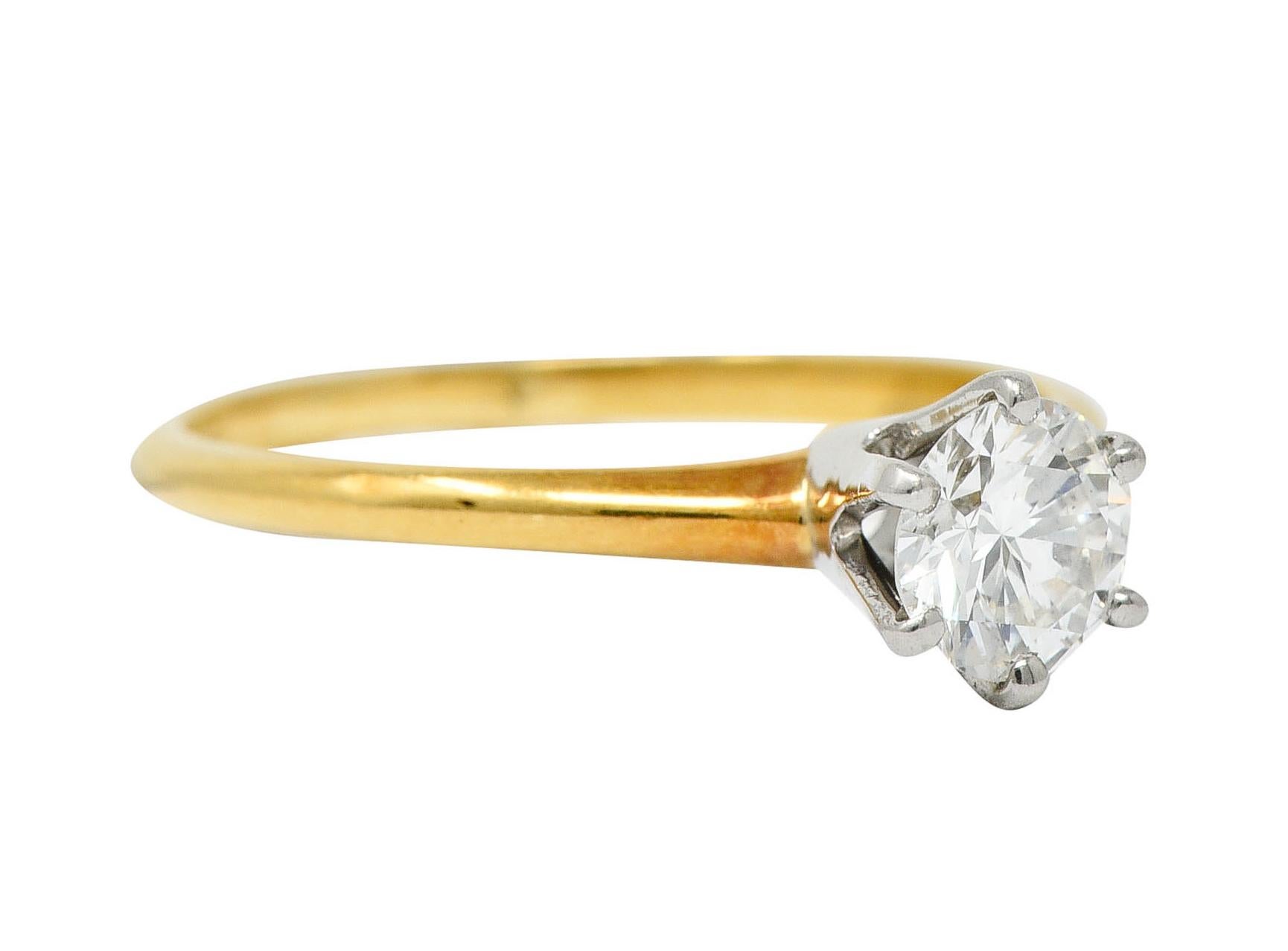 Classic solitaire ring centers a round brilliant cut diamond

Weighing approximately 0.35 carat with G color and VS1 clarity

Set in a six pronged platinum head and completes as a polished yellow gold shank

Stamped for platinum and 14 karat