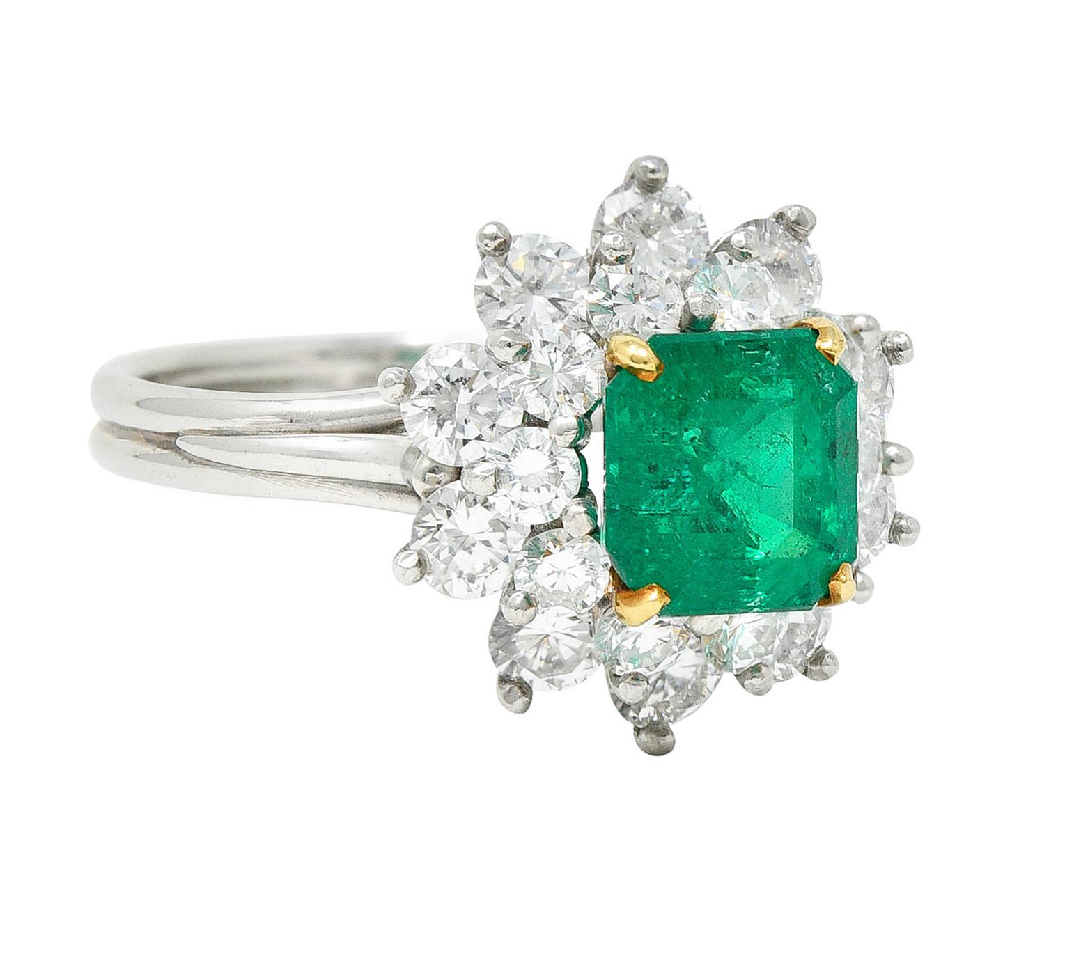 Featuring an emerald cut emerald weighing approximately 1.50 carats

Vividly and uniformly green and semi-transparent with natural two-phase inclusions - one surface reaching

Set by yellow gold prongs and surround by a double diamond