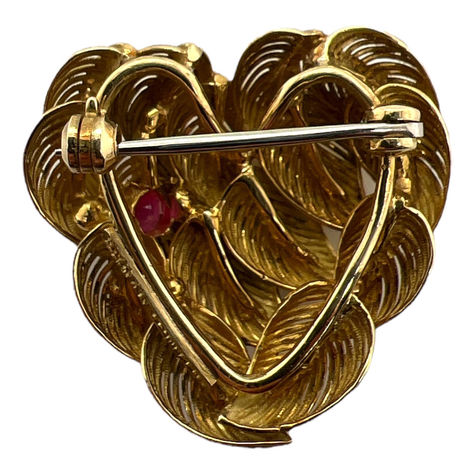 Beautifully crafted ruby heart brooch by Tiffany & Co. The rare vintage heart is made of overlapping leaves and features a single ruby. The brooch measures approximately 28 x 28mm. 