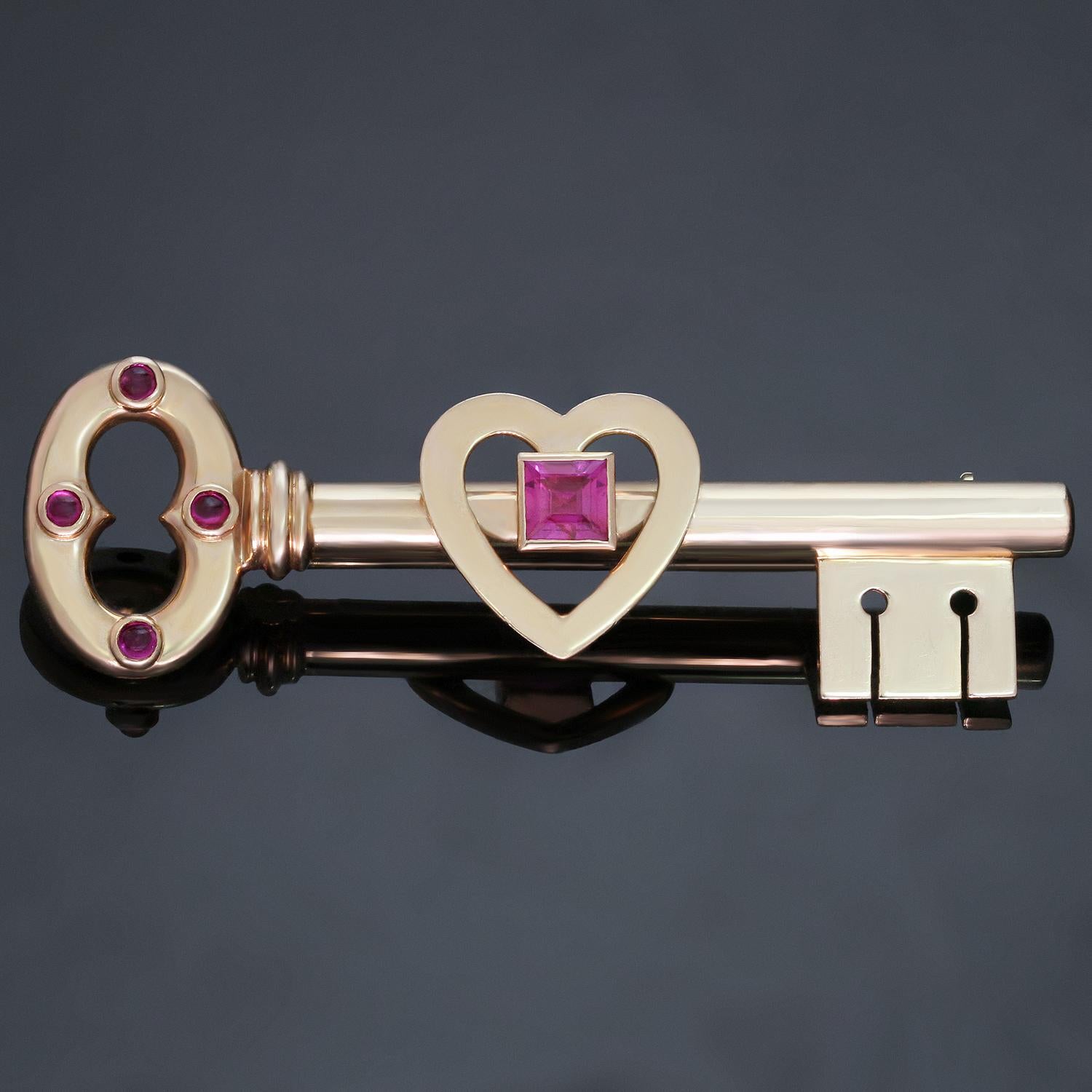 This rare retro Tiffany & Co. brooch features a design of a key with a heart-shaped motif crafted in 14k rose gold and set with 4 round cabochon pink sapphires and one square pink sapphire. Made in United States circa 1950s. Measurements: 0.66