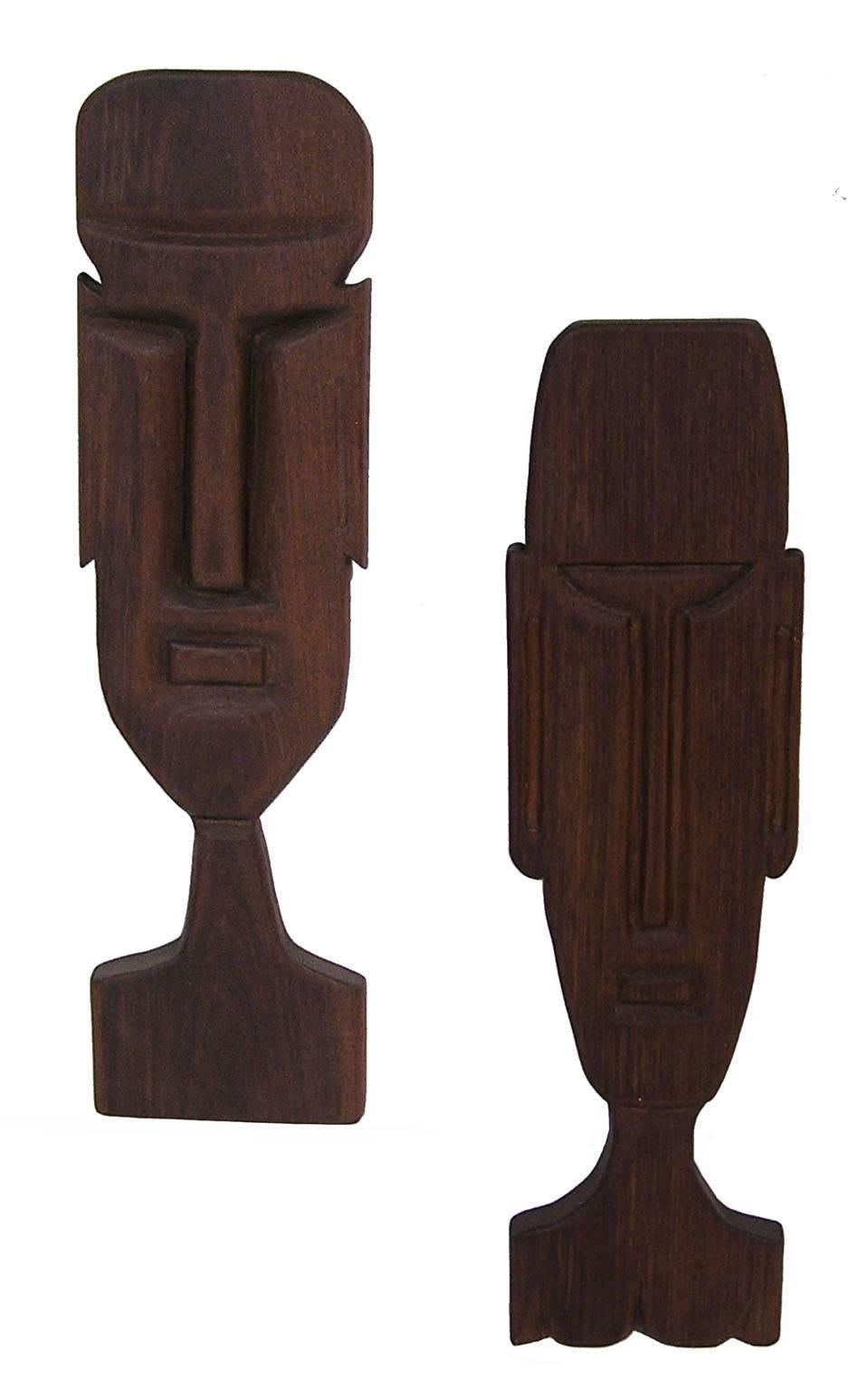 A pair of figural solid teak wall hangings from the 1950s Tiki Modern era. Beautiful craftsmanship throughout depicting the head and upper body of a man and woman. Overall excellent condition.