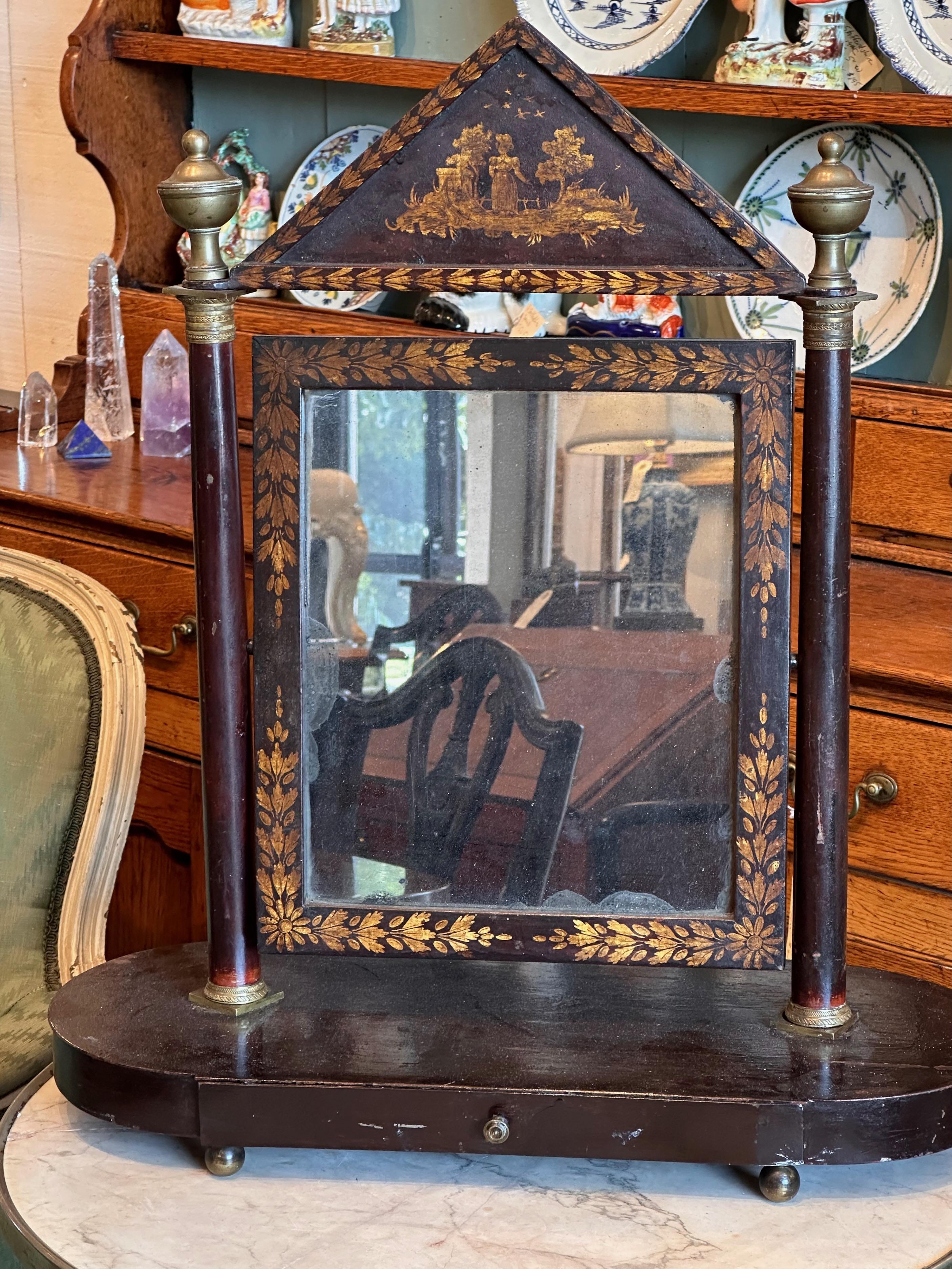 We love tole and dressing mirrors. This is an Empire period dressing mirror. It has one drawer.