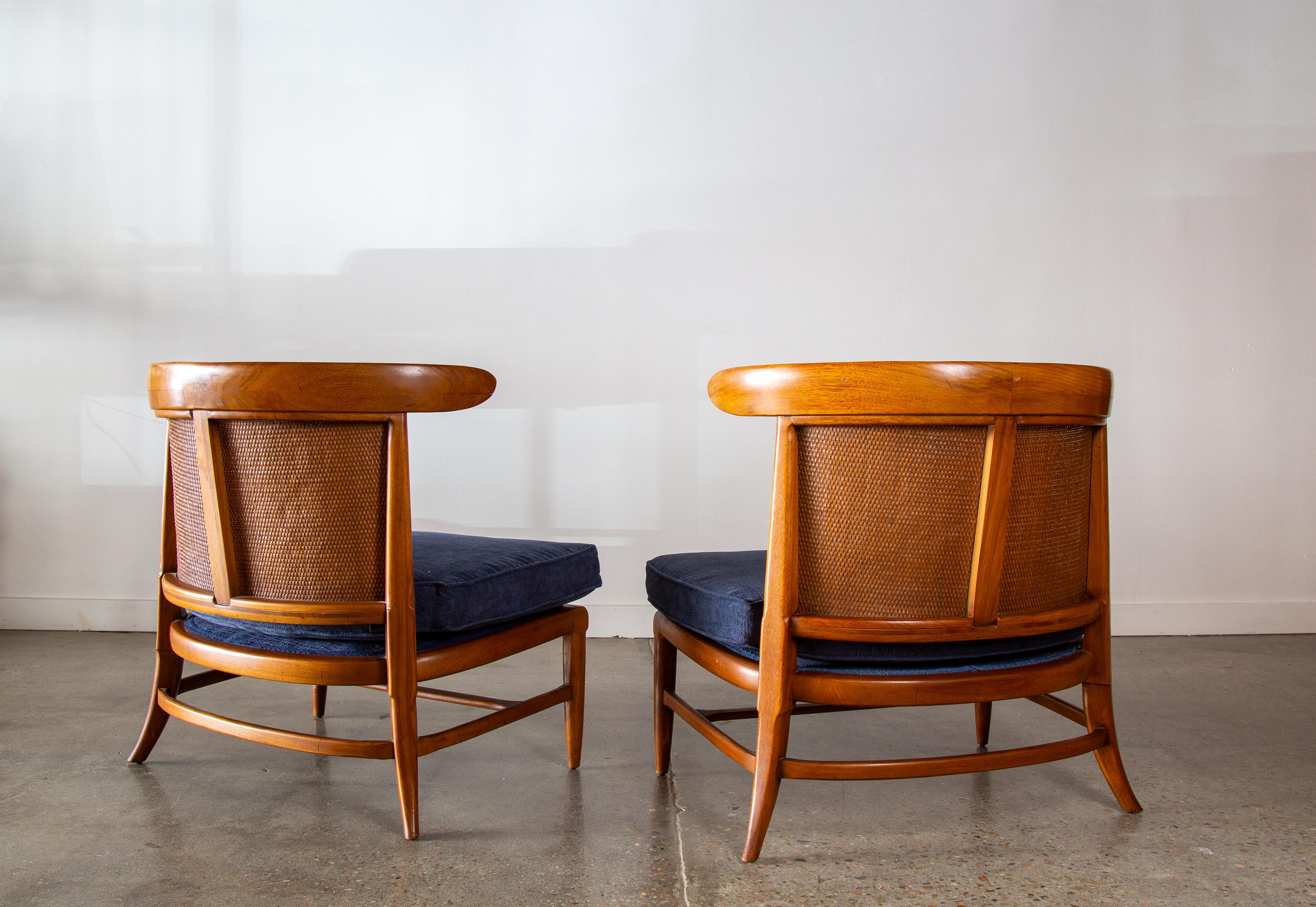 Pair of slipper chairs in chestnut and densely woven cane backs designed by John Lubberts and Lambert Mulder for Tomlinson Furniture Company.  These are a part of the sophisticate line and have an elegant form with curved saber form legs. The cane