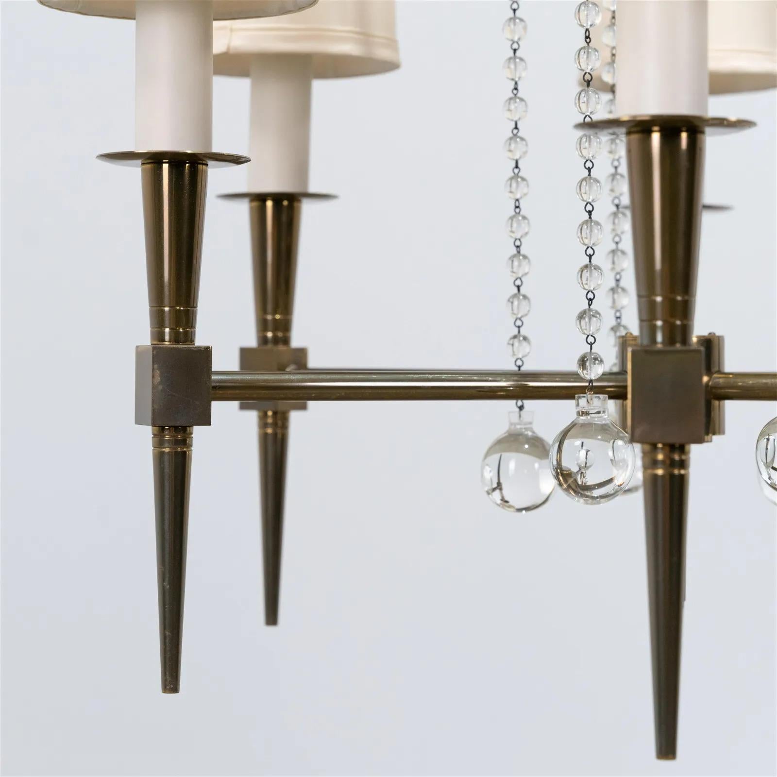 Elegant, 1950s Tommi Parzinger for Parzinger Originals, 6 arm brass and crystal chandelier. This chandelier has silk shades. Model No. 1 in brass with suspended crystal beads.