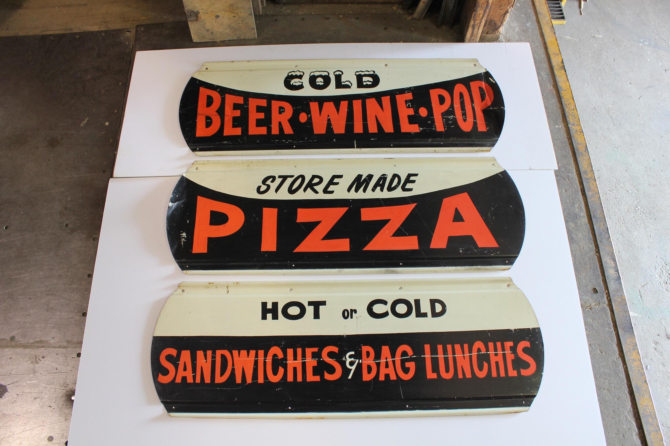 1950s trio of hand-painted on metal diner signs: Cold Beer Wine Pop; Store Made Pizza; Hot and Cold Sandwiches and bag lunches. Each sign: H 16