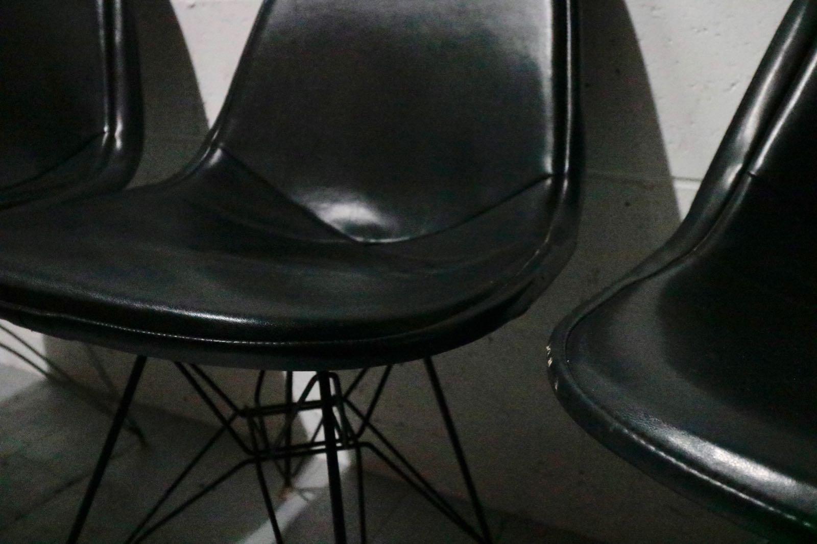 A Trio of early Charles & Ray Eames DKR chairs with original Vinyl, wire and steel base, circa 1950s. Featuring 'Eiffel' bases.
Two white backed wire and one black.
These are original chairs in their original condition.
 