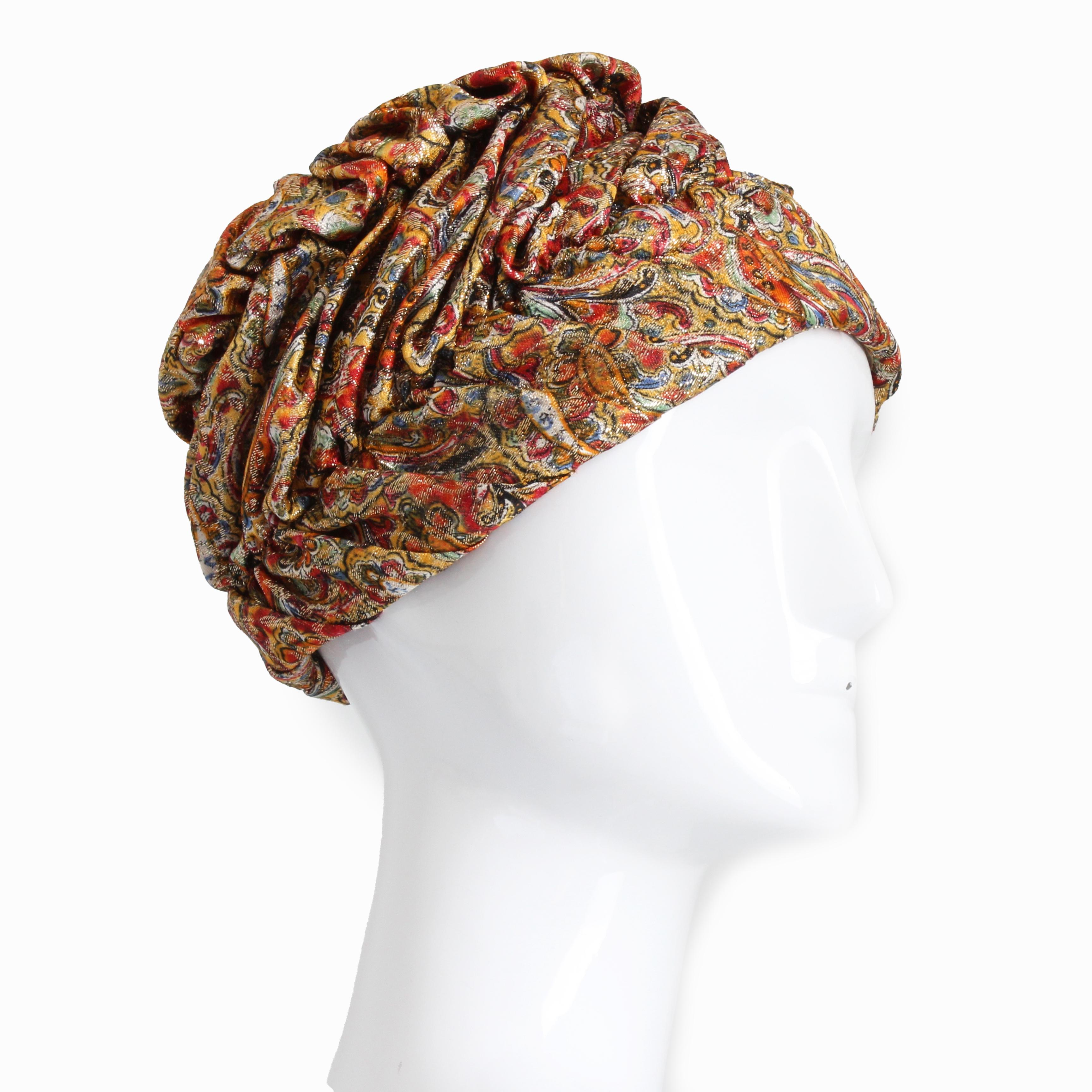 This fabulous vintage turban style hat was made by Marshall Field & Company, most likely in the early 1950s. 

Made from a shimmery metallic paisley fabric, it is fully lined in cream silk with netting overlay.   

Definitely a jet set retro vibe