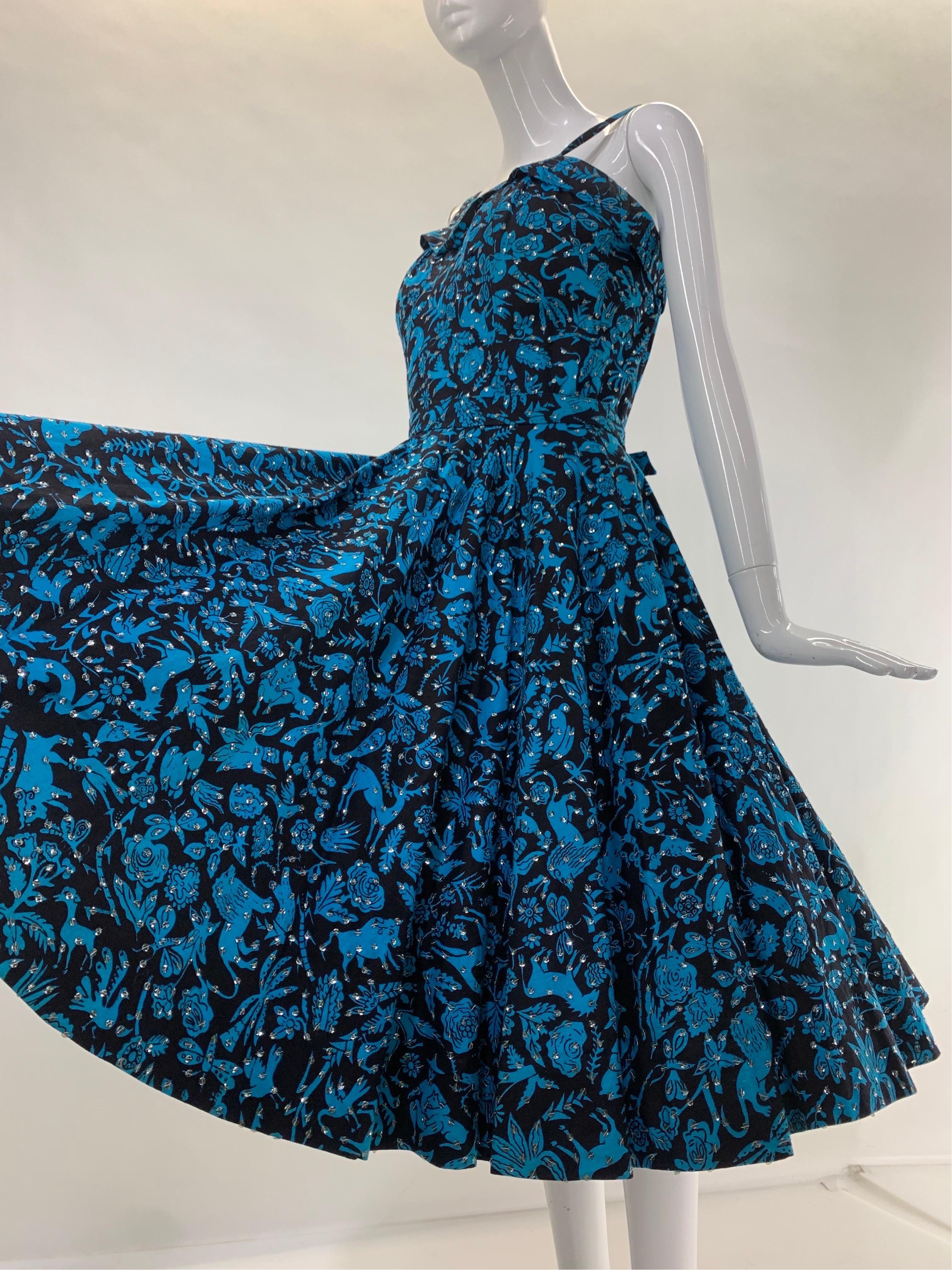 1950s Turquoise & Black Folkloric Print Cotton Summer Dress w/ Scattered Silver Sequins: Fit and flair silhouette and doubled spaghetti straps. Unlined (shown with a crinoline, not included) full circle skirt. Unlabeled vintage made in Mexico. Size