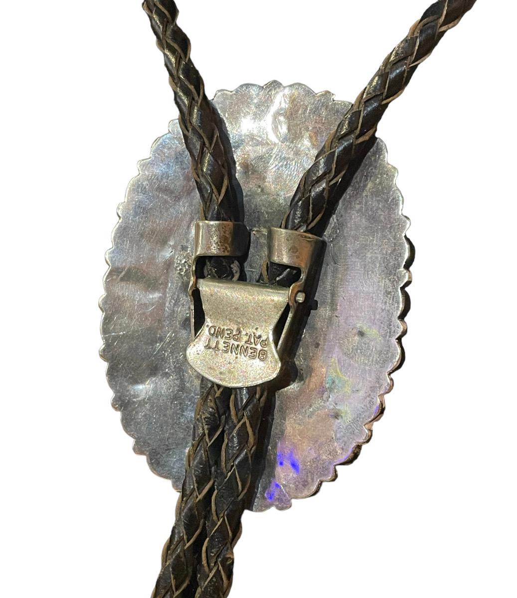 1950s Rare Turquoise Stone Sterling Silver Western Bolo Tie with Bennett Pat Pend. Clasp to Adjust.

Black Genuine Leather Woven Straps with Sterling Silver Tips

39 Turquoise Stone Set in Sterling Silver Oval Mandala-Like Pattern , No Stones