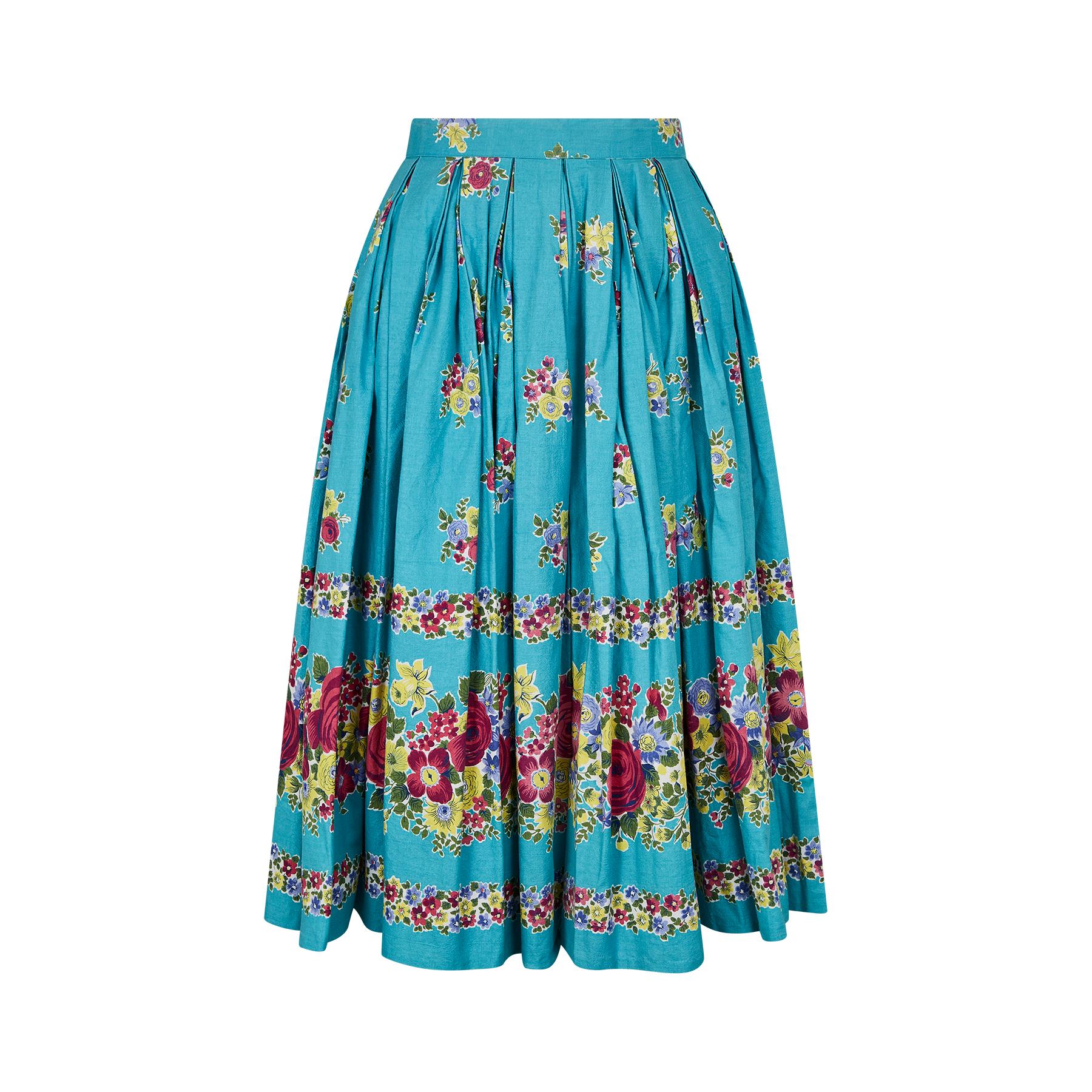 This is the most darling original vintage 1950s floral cotton box pleated skirt. In a vivid turquoise blue base colour which is set off with a striking floral pattern that has several size versions combining in various forms to provide a graduated