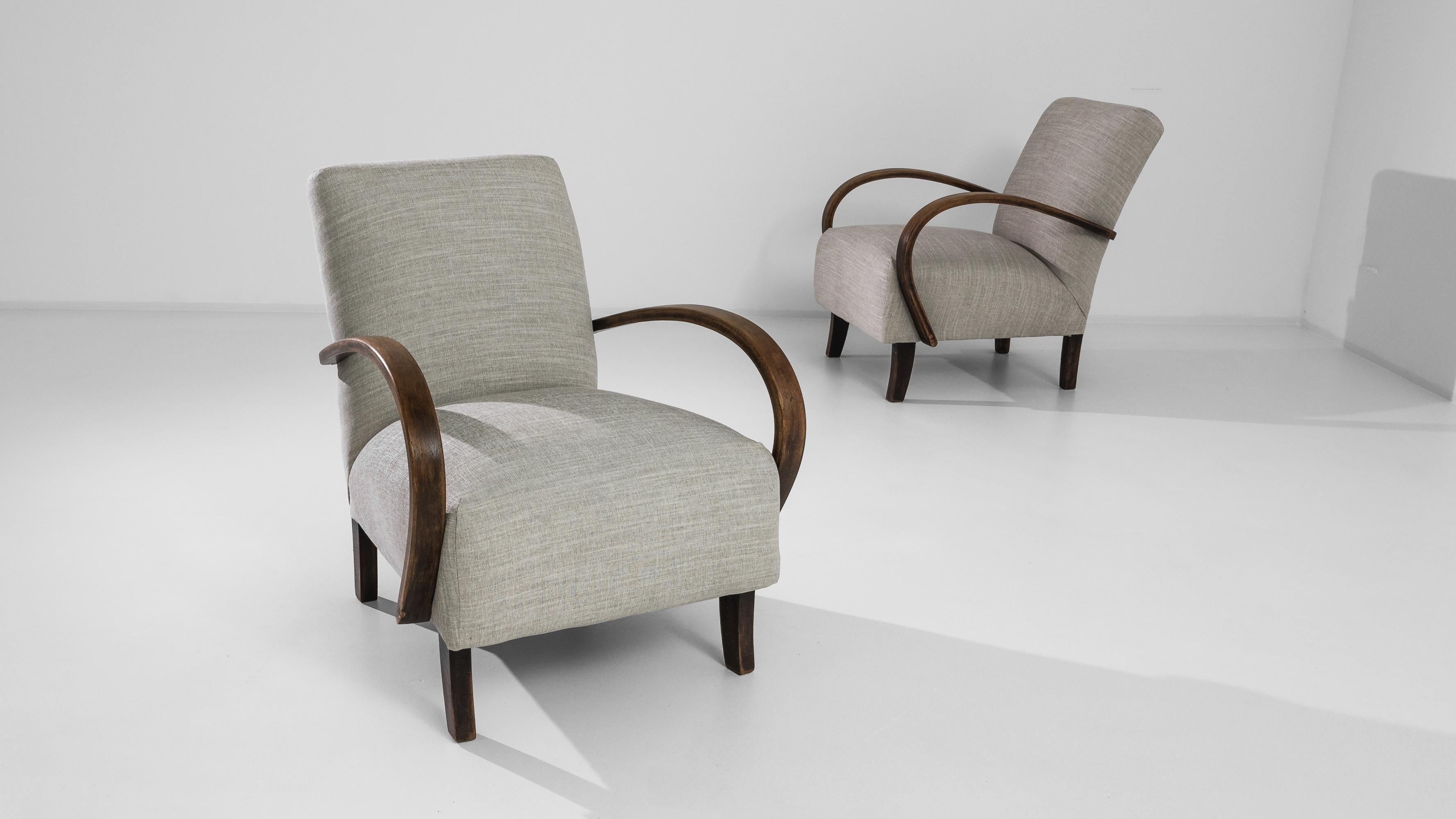 A pair of armchairs by Czech furniture designer J. Halabala. Made in the 1950s, distinctive bentwood furniture designs were produced in Central European furniture factories throughout the mid-20th Century. The eye-catching silhouette and comfortable
